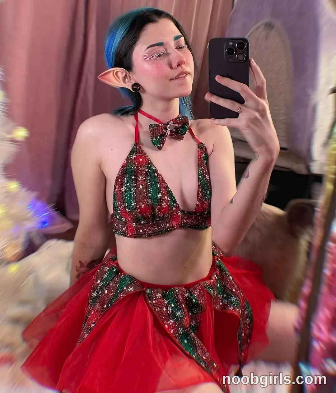 Alice Holding a smartphone up toward a mirror to take a selfie
