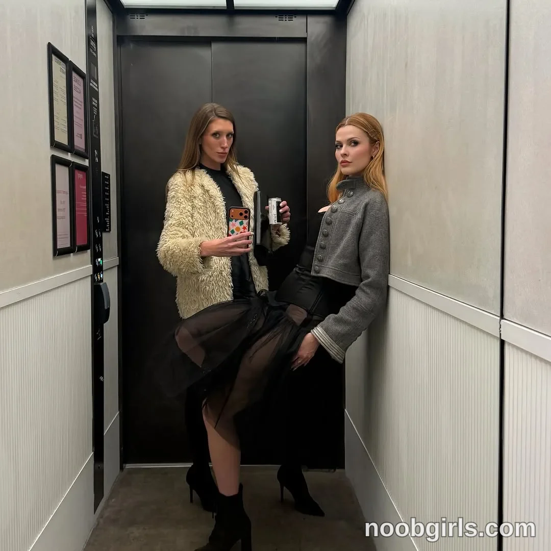 Addison Vodka Two women are posing in an elevator. The woman on the left holds a smartphone toward the mirror