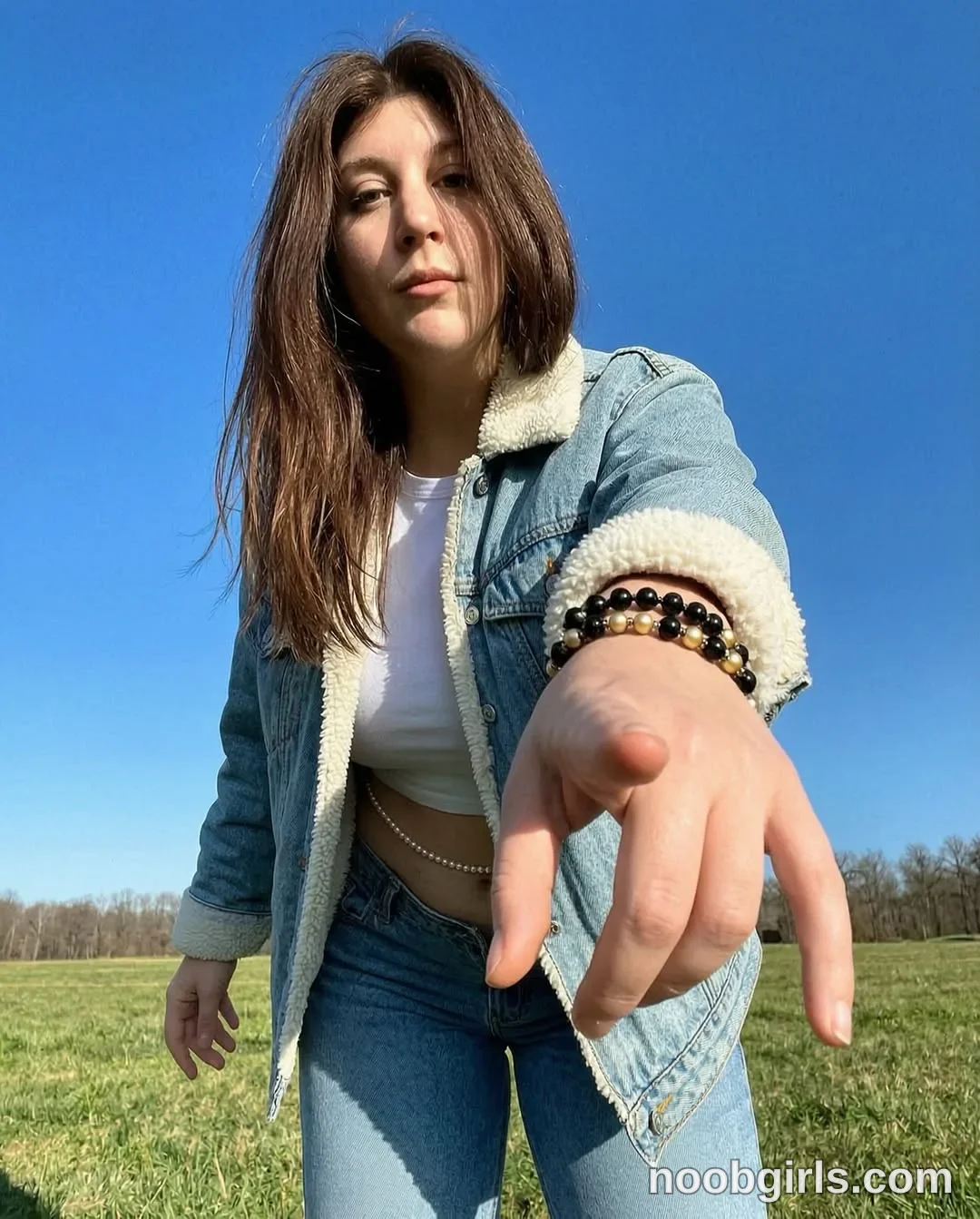 alexadream reaching right hand forward toward the camera