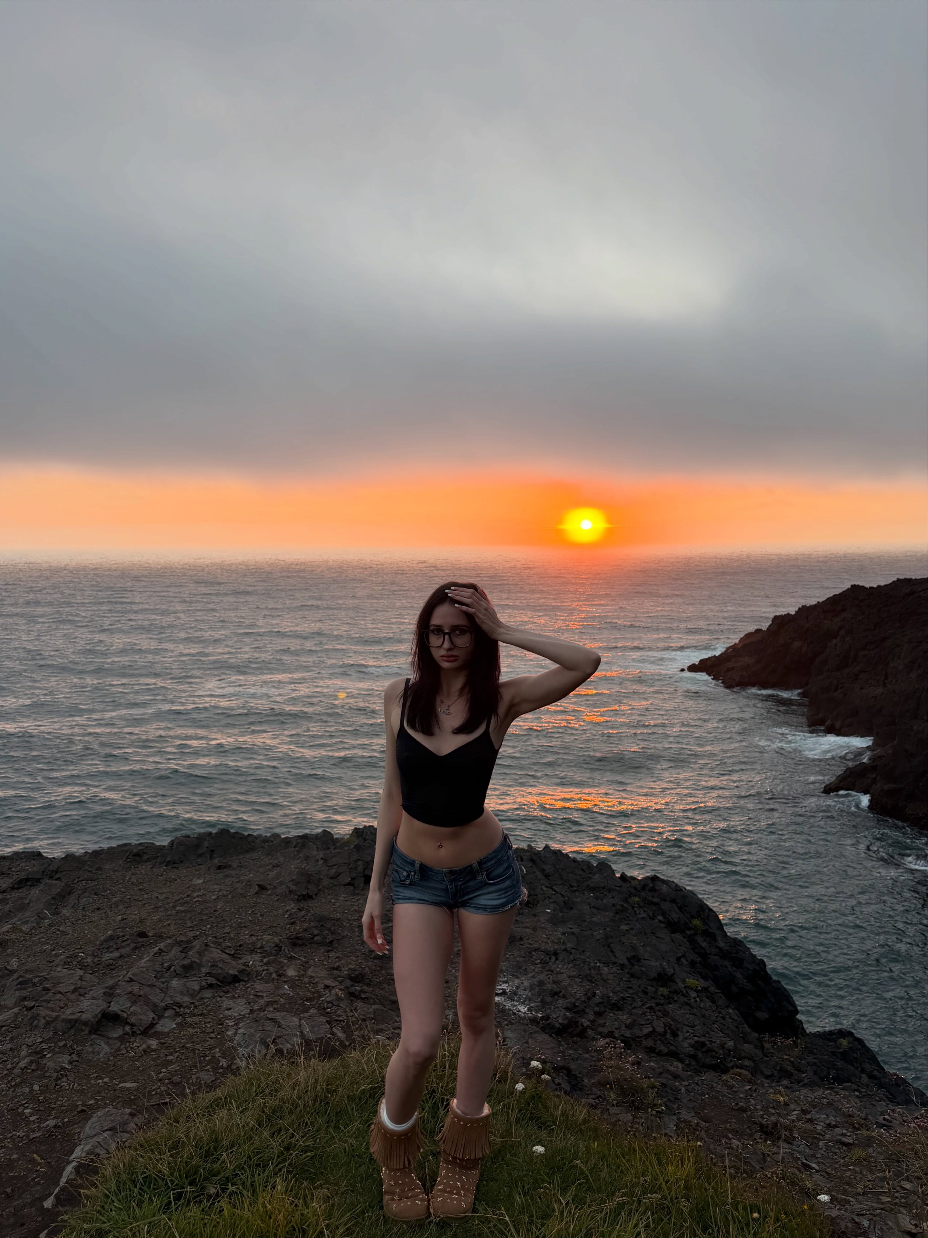 alyssapearls wearing black crop top in coastal cliff