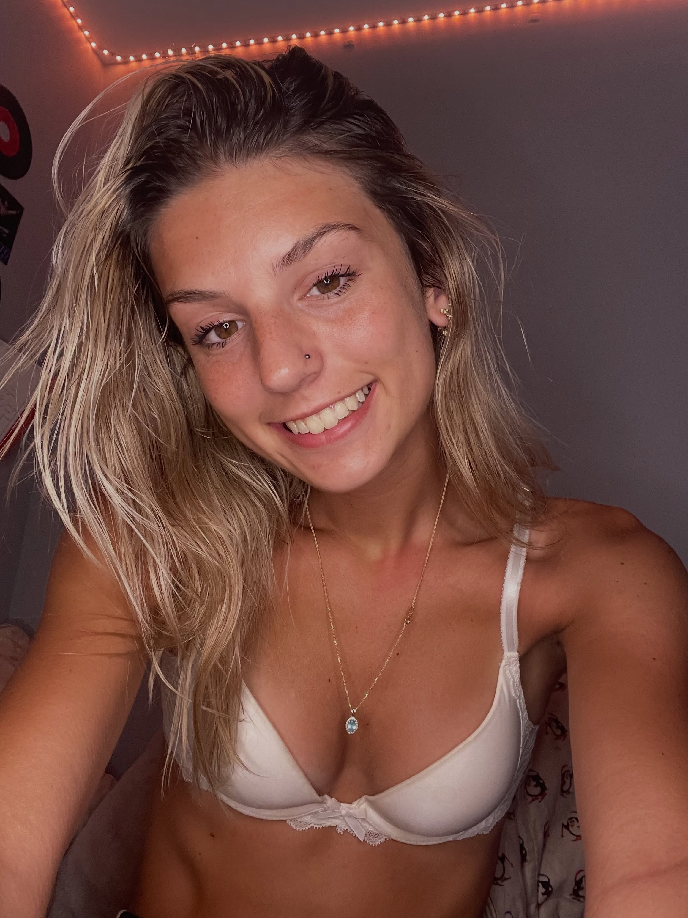 ambiebambiii taking a selfie wearing white bra with lace trim in bedroom or living space