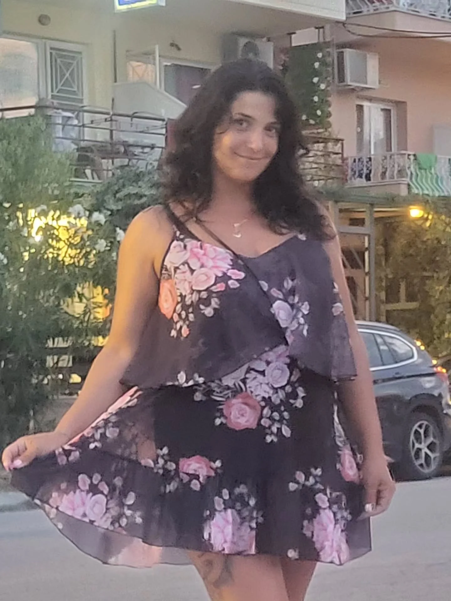 anaworld69 wearing black floral print dress in street outside residential building