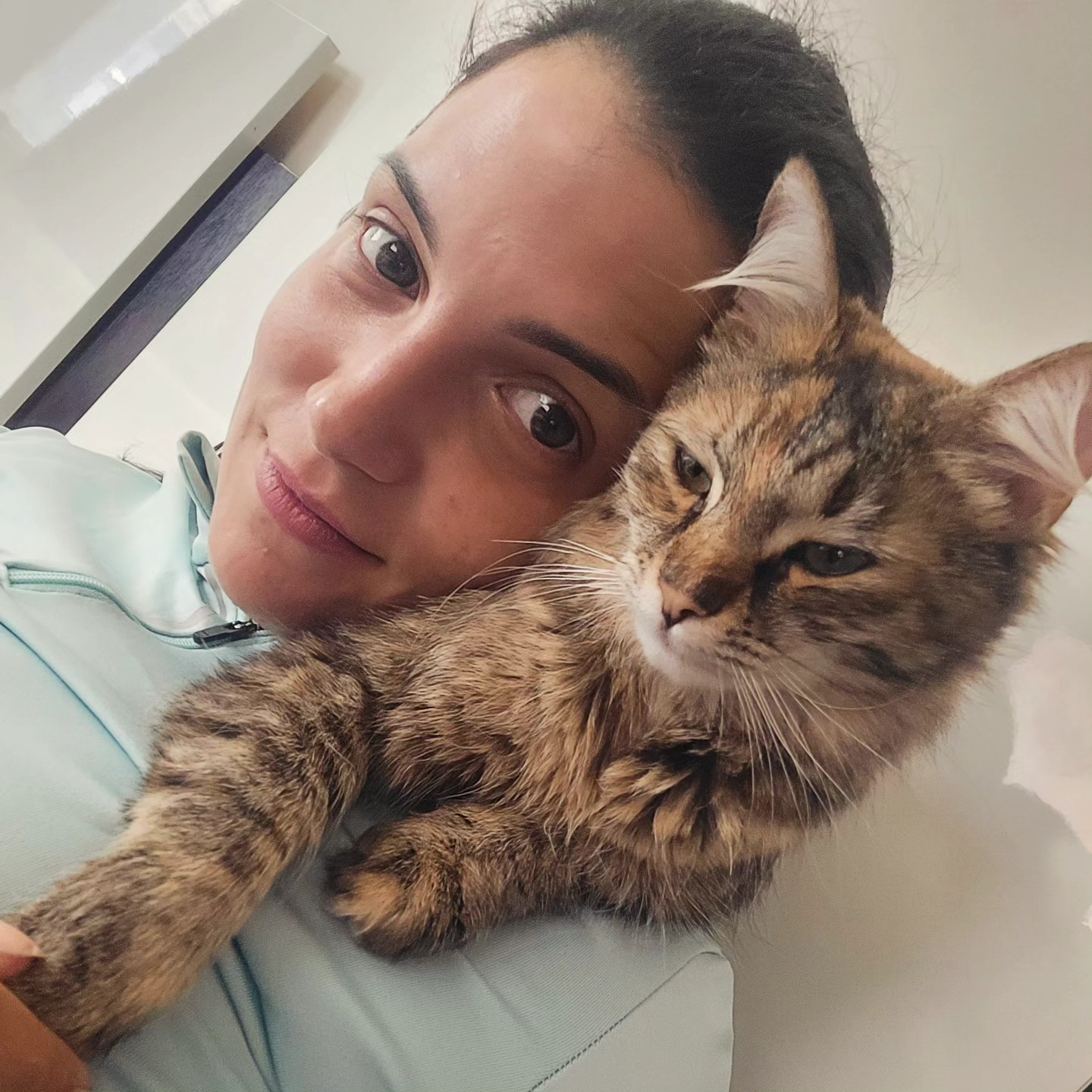 anaworld69 holding cat wearing light blue top