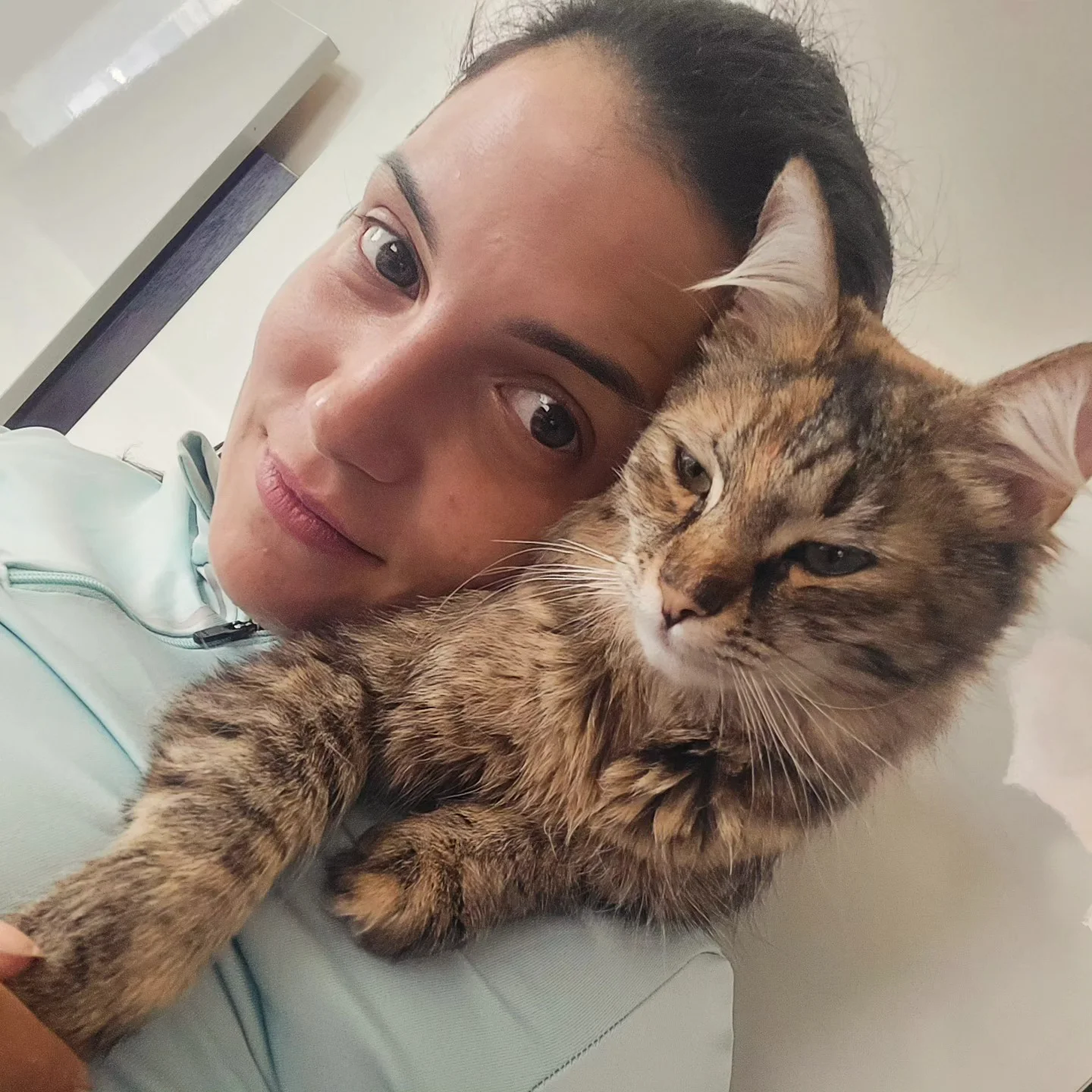 anaworld69 Holding a cat wearing light blue jacket