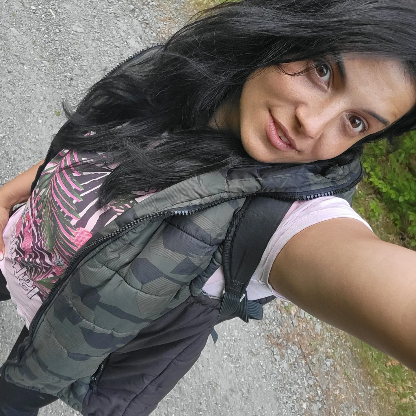 anaworld69 taking a selfie wearing camouflage puffer vest in trail