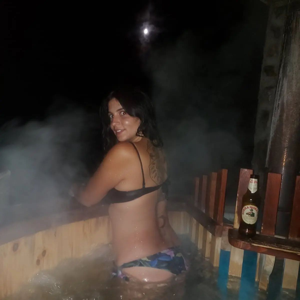 anaworld69 sitting in hot tub wearing black bikini top in wooden hot tub
