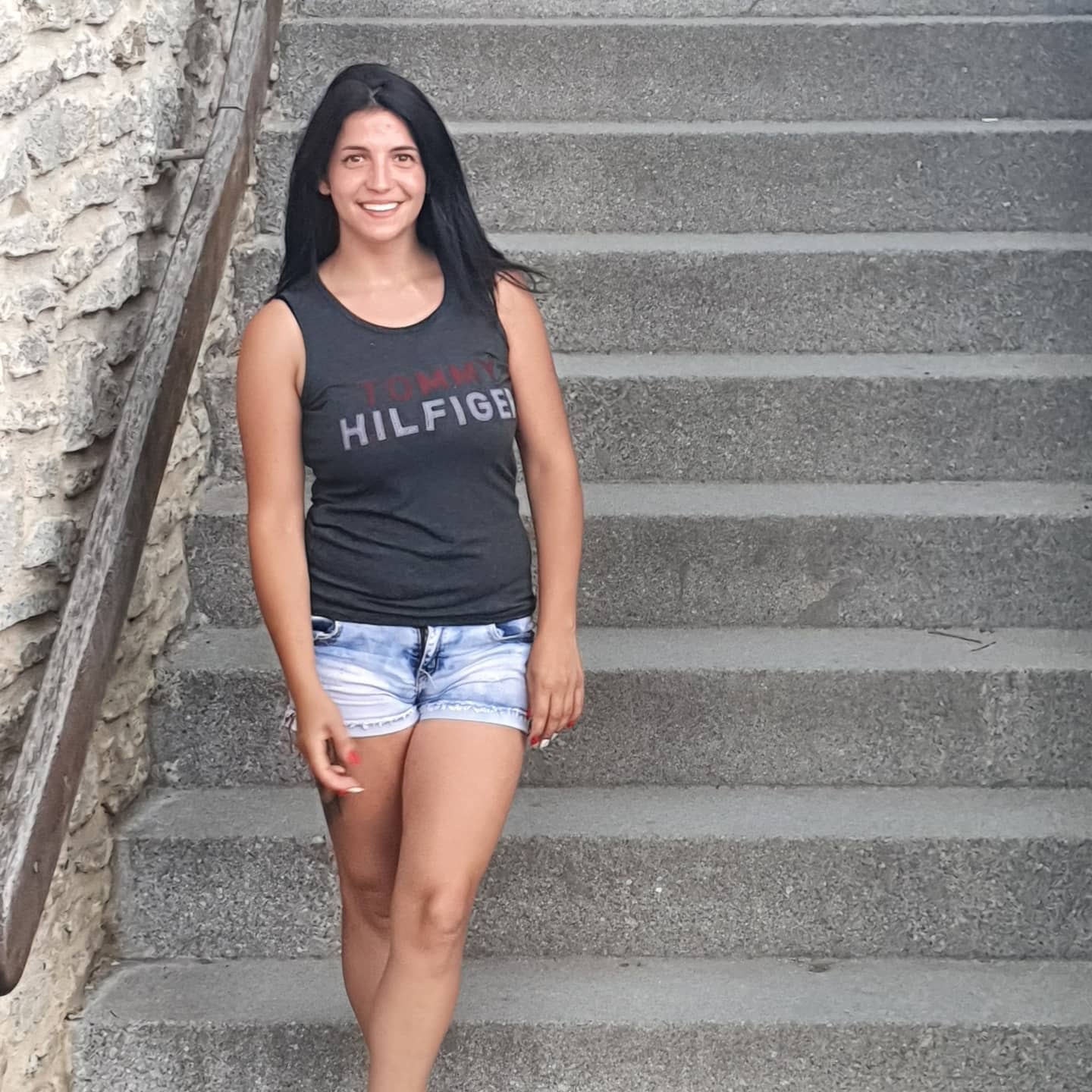 anaworld69 standing on stairs wearing grey sleeveless top in stairs