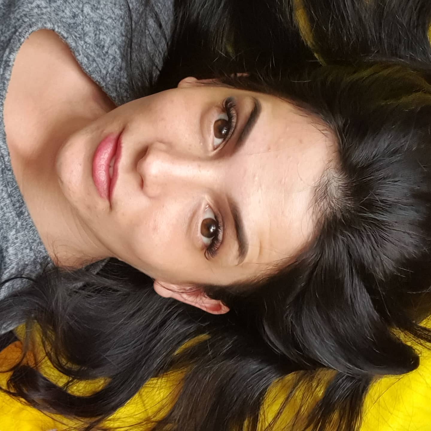 anaworld69 lying down wearing grey top
