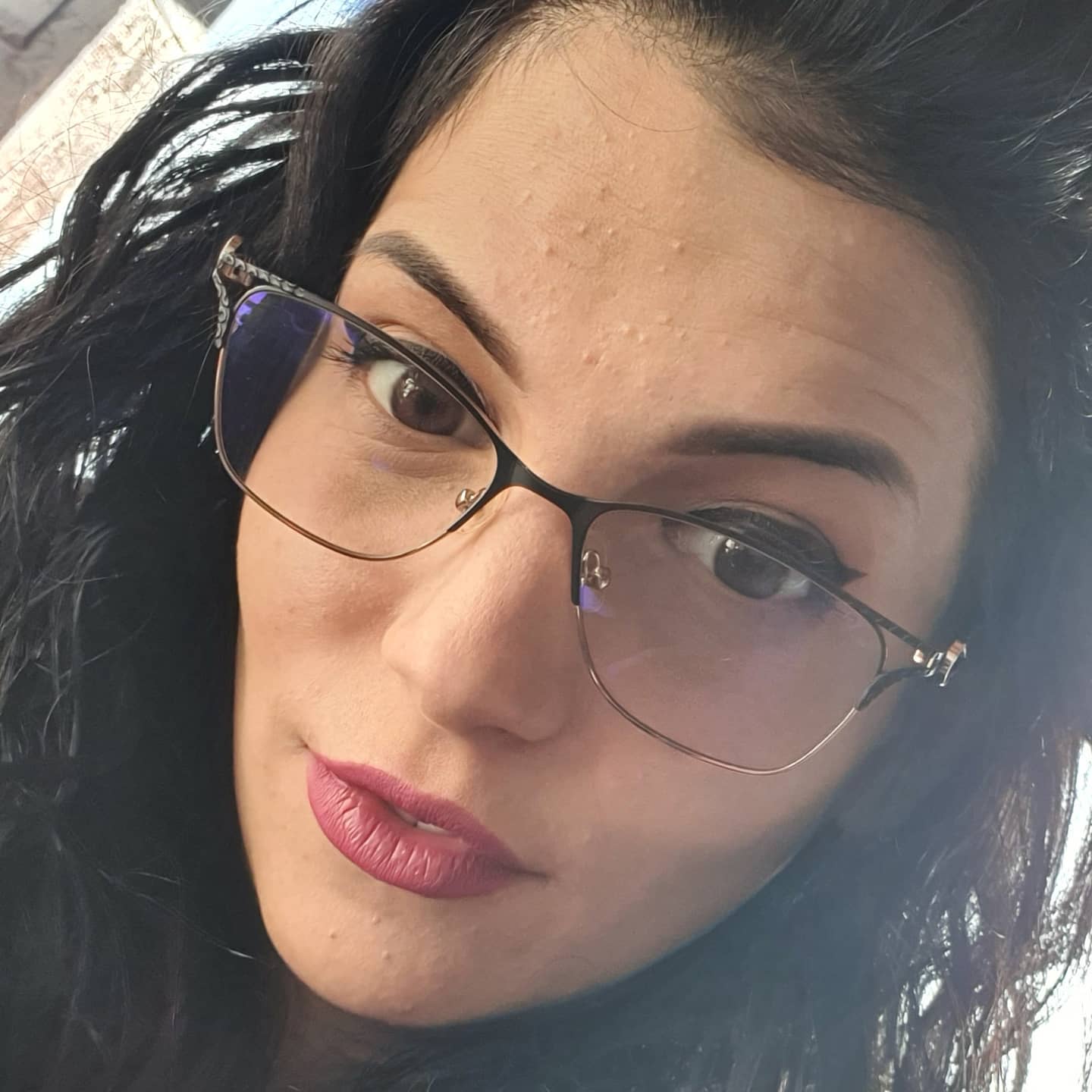 anaworld69 wearing eyeglasses with dark frames