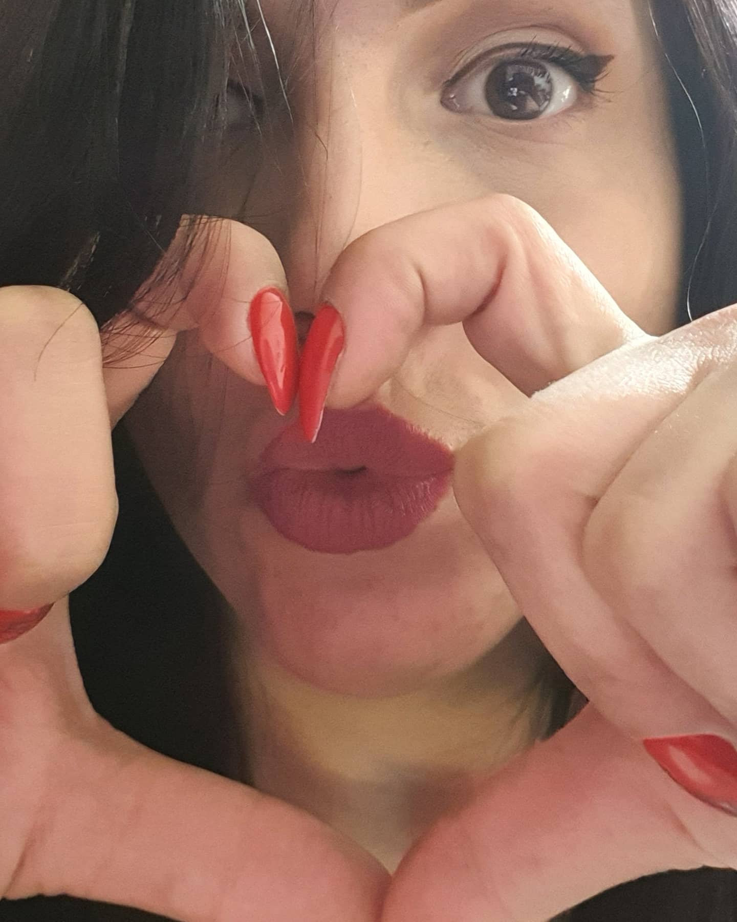 anaworld69 making heart hand gesture
