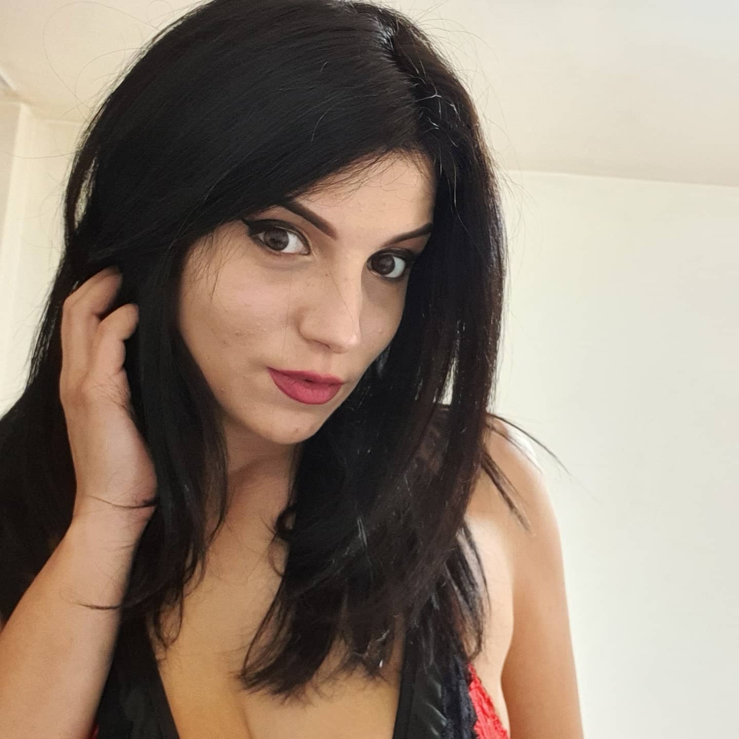 anaworld69 touching hair wearing black and red top