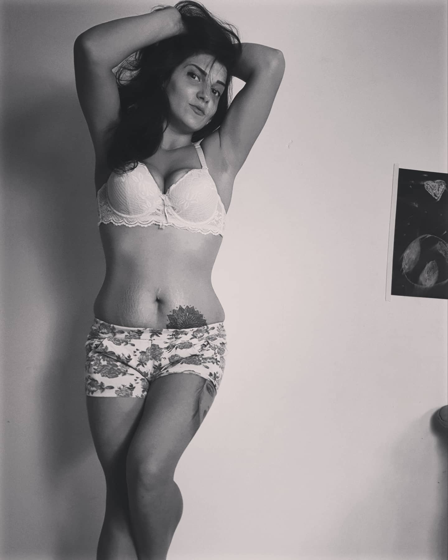 anaworld69 posing with hands behind head wearing light-coloured bra