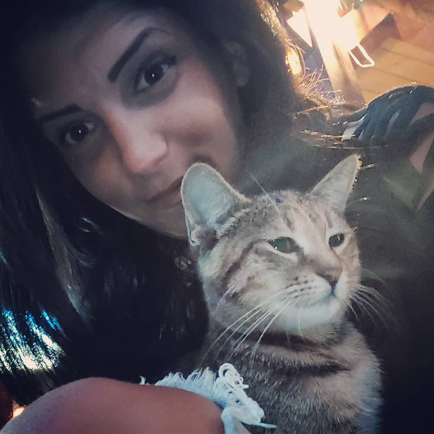 anaworld69 holding a cat wearing dark top