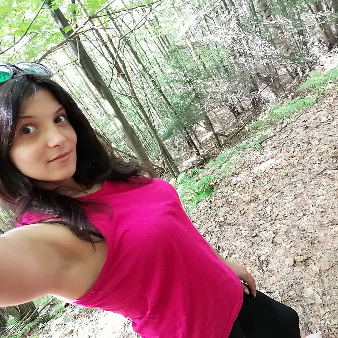 anaworld69 taking a selfie wearing pink sleeveless top in forest path