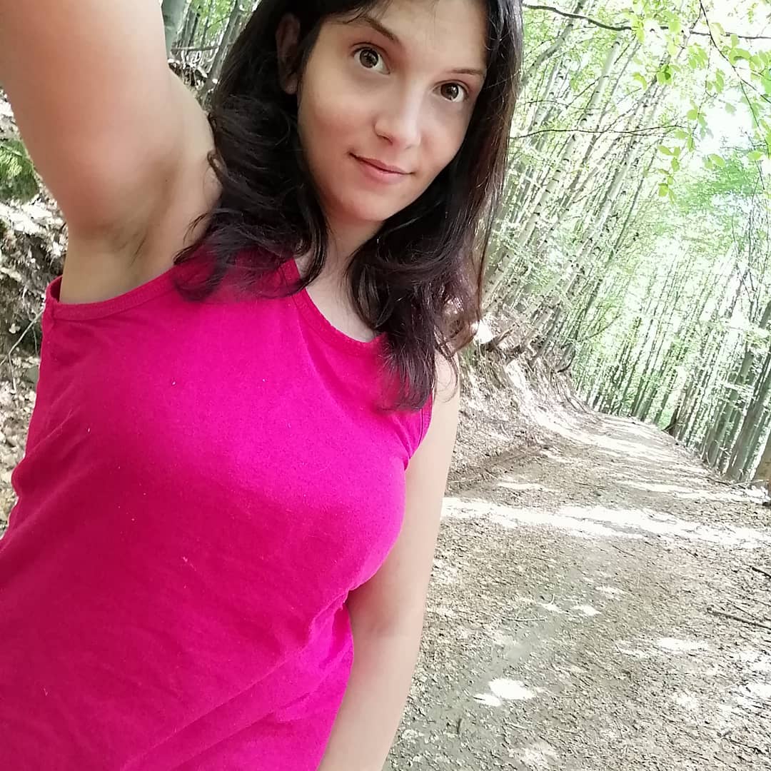 anaworld69 taking a selfie wearing pink tank top in forest path