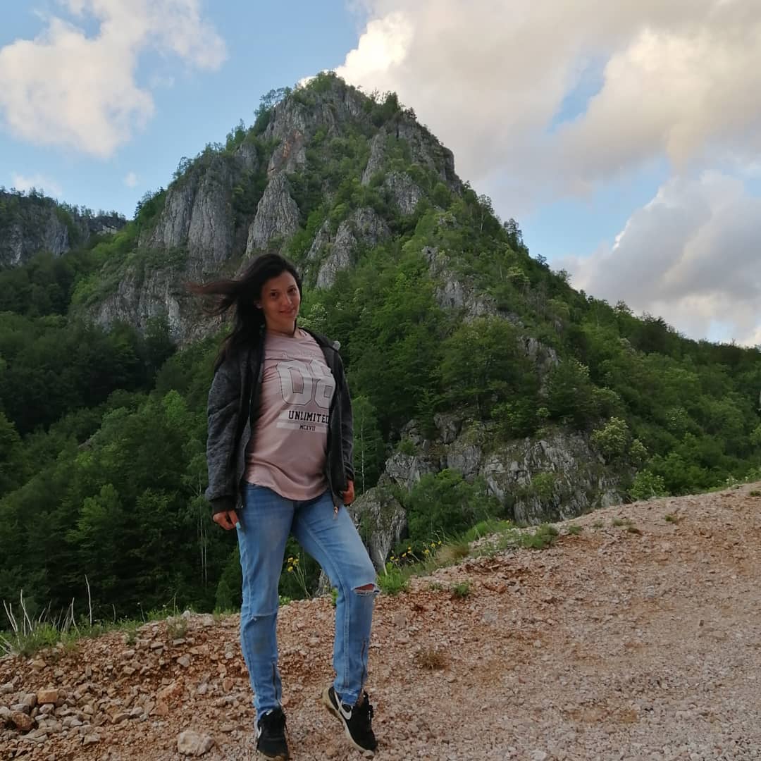 anaworld69 wearing pink graphic t-shirt in mountain roadside