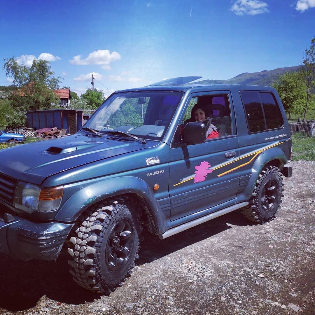anaworld69 sitting in driver's seat wearing red top in rural outdoor road