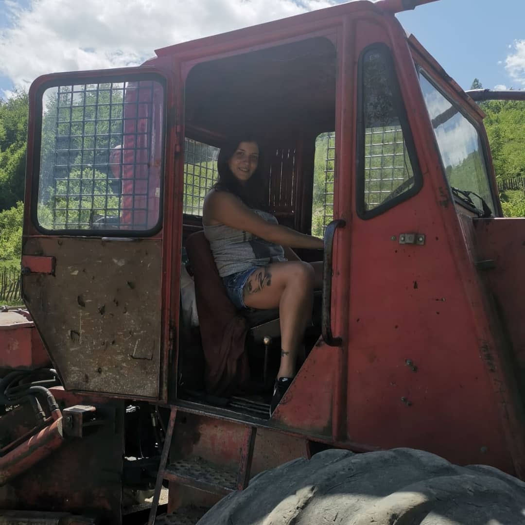 anaworld69 sitting in vehicle cab wearing grey tank top in vehicle cab