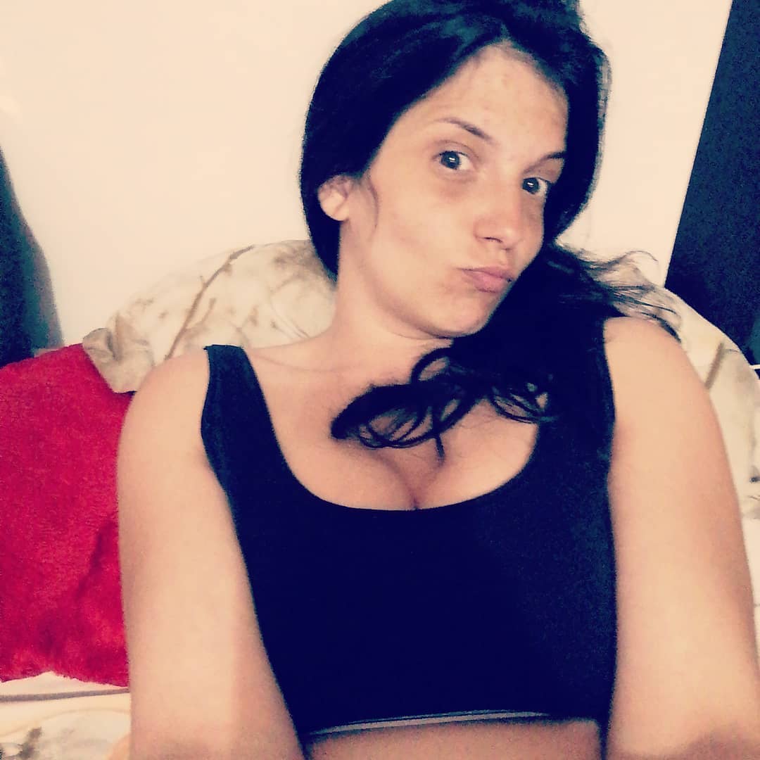 anaworld69 posing for selfie wearing black tank top in bedroom