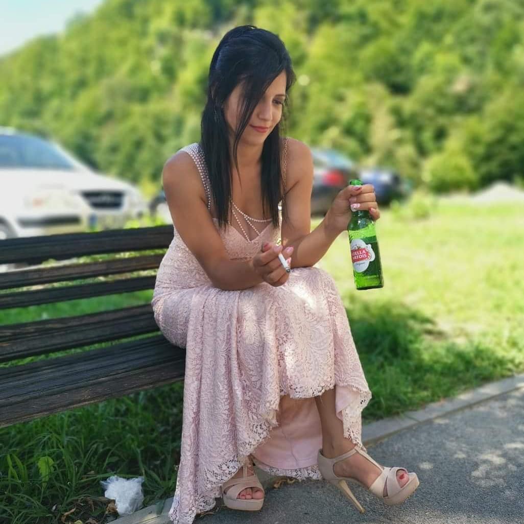 anaworld69 holding a beer bottle wearing light pink lace dress in park area