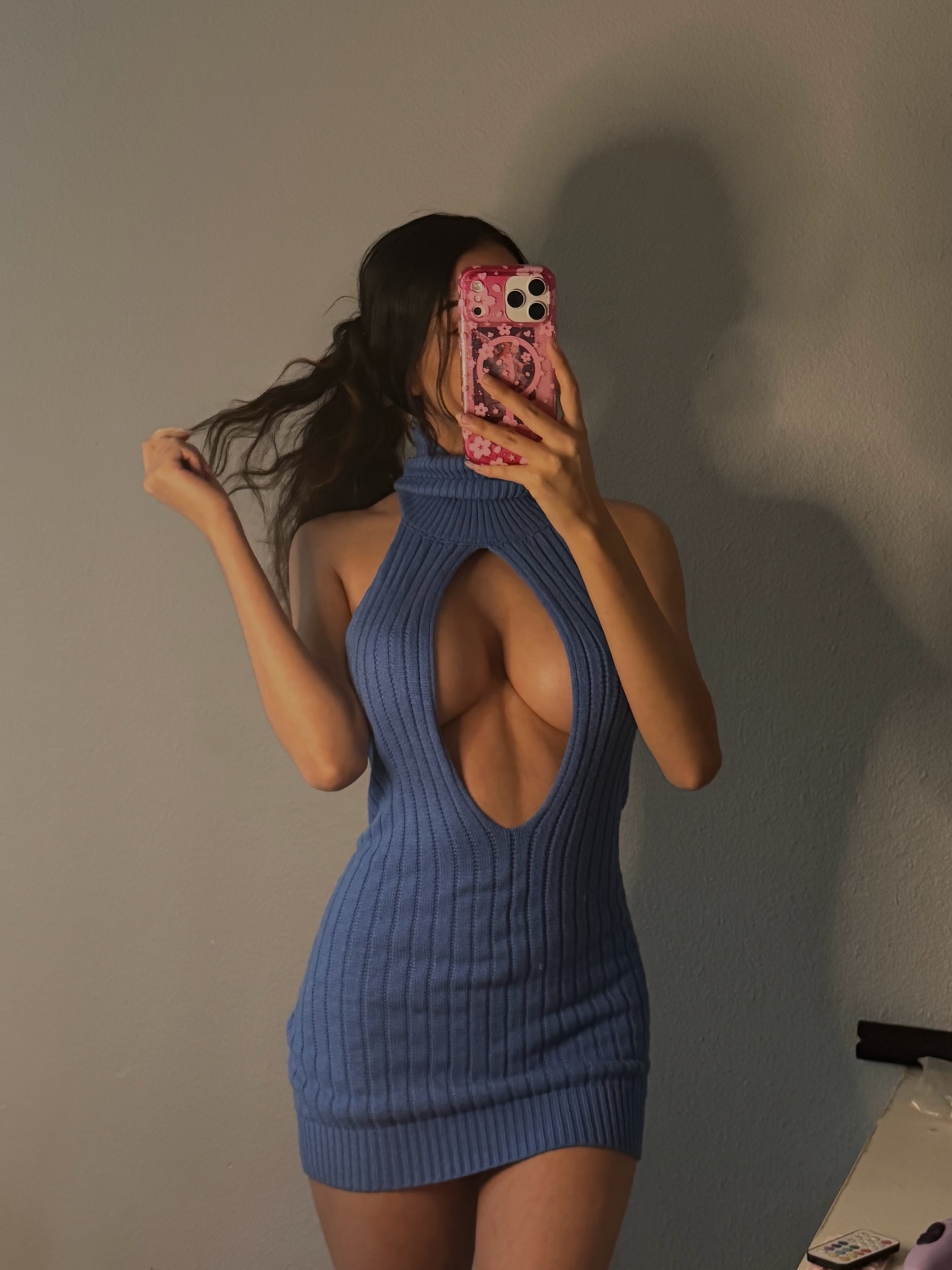 angelllsworlddd taking a mirror selfie wearing blue ribbed knit cutout dress