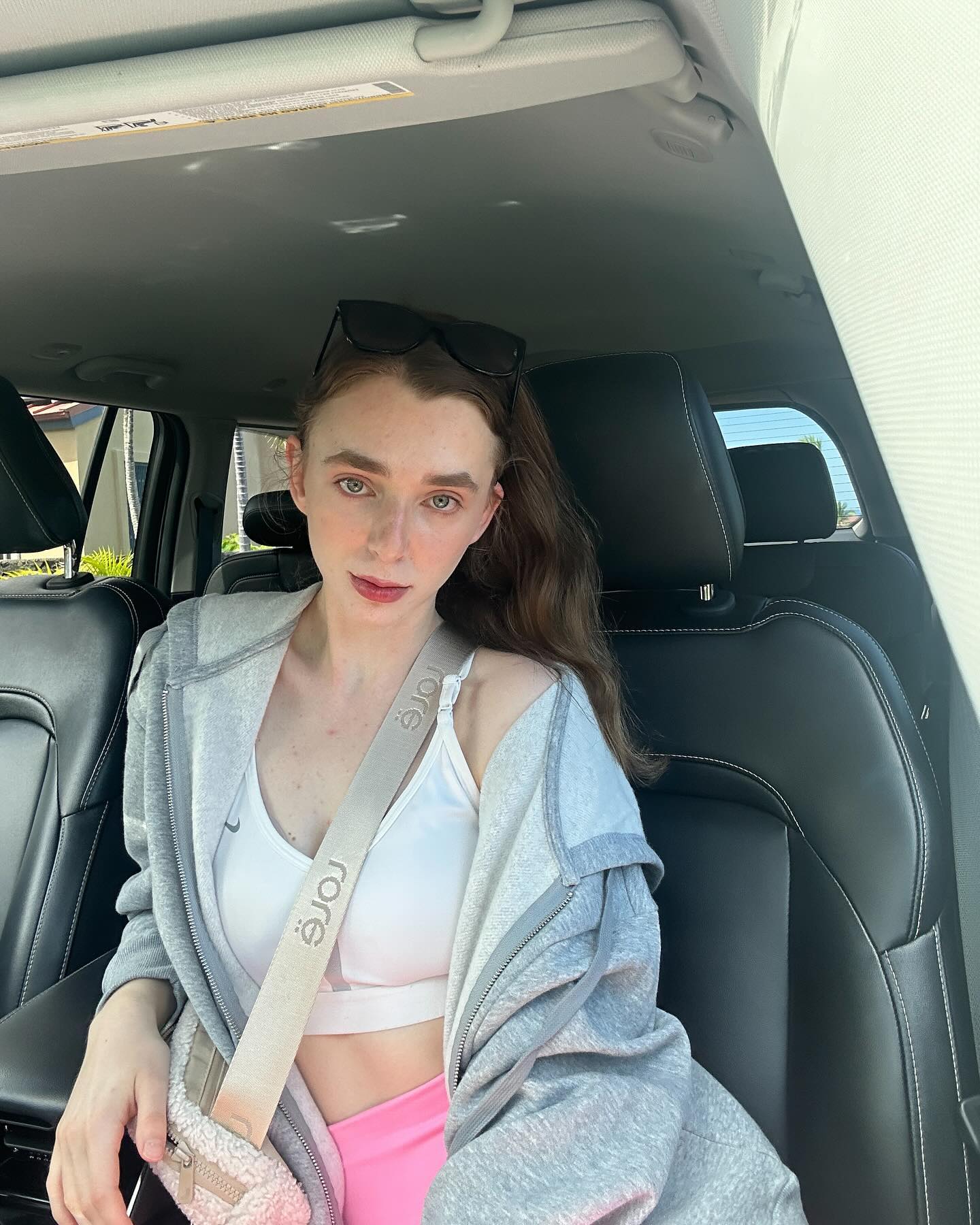 annabisoux sitting in car wearing grey hoodie in car interior