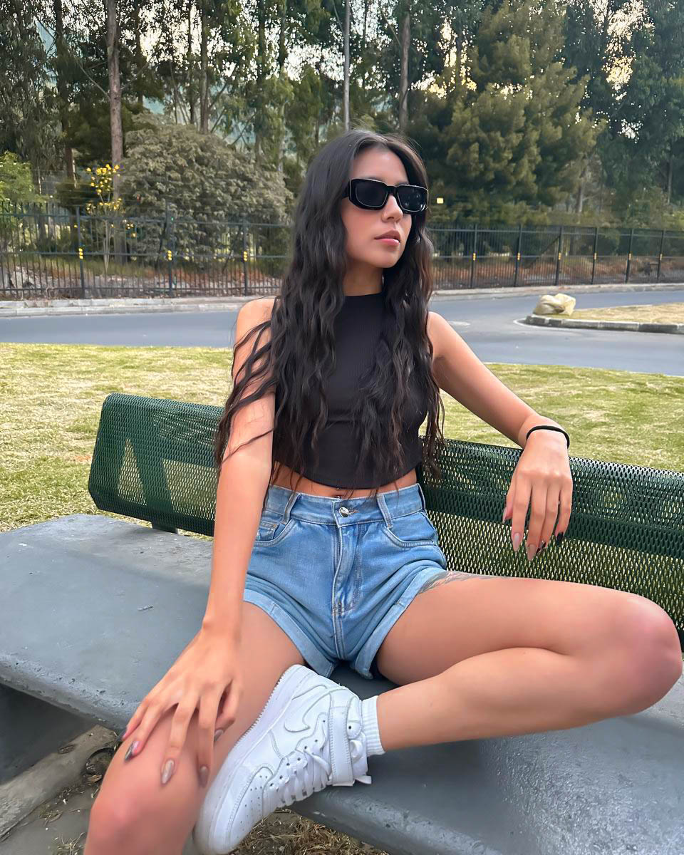 ashley_jones9 sitting on a bench wearing black crop top in park bench