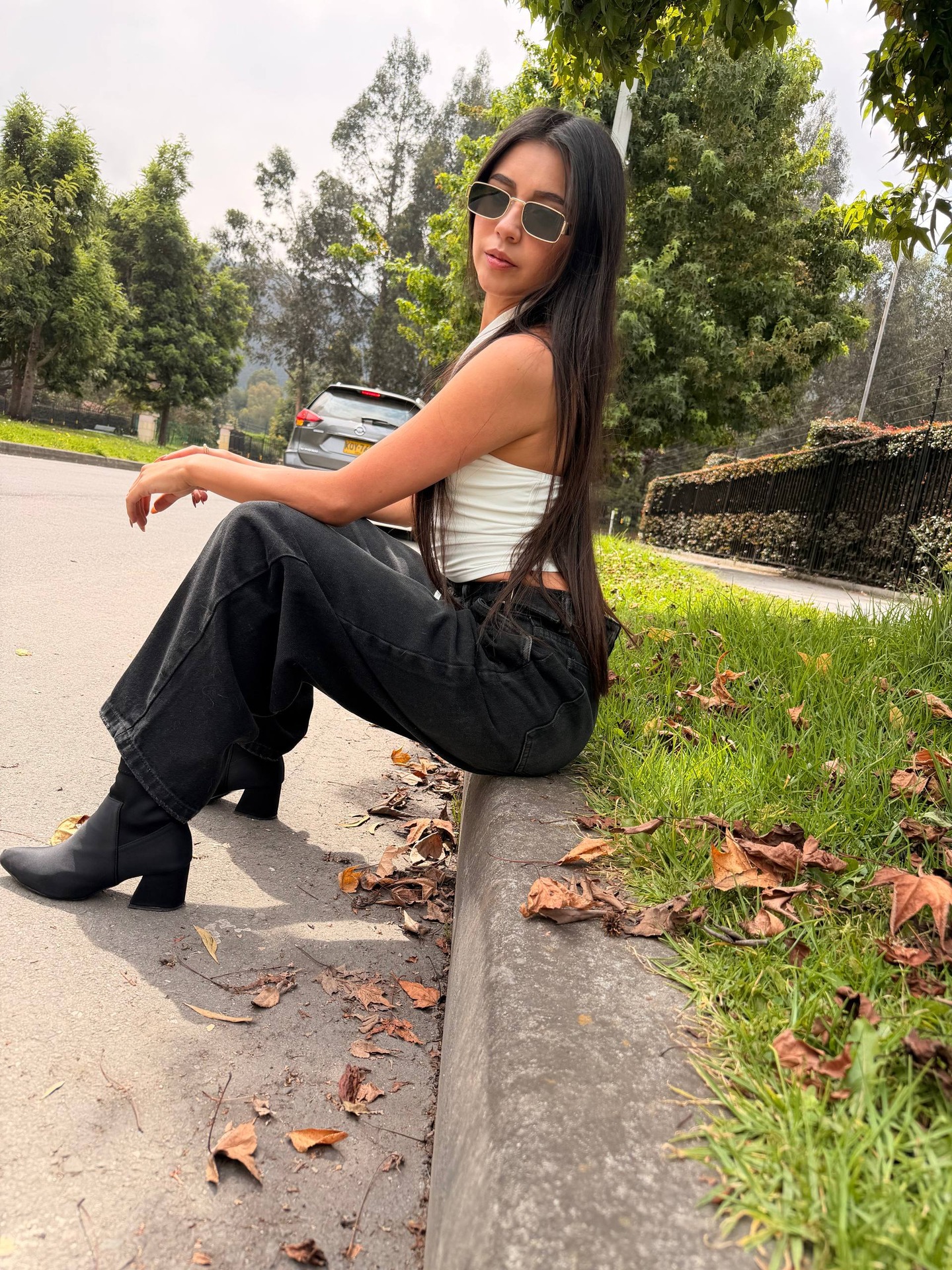 ashley_jones9 sitting on a curb wearing white halter top in curbside