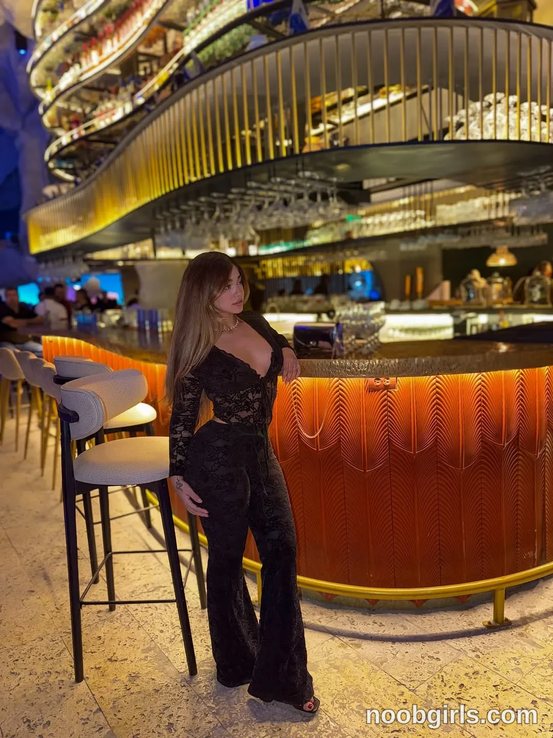 Ale wearing black lace long-sleeve crop top in bar or restaurant lounge in SB Acuario