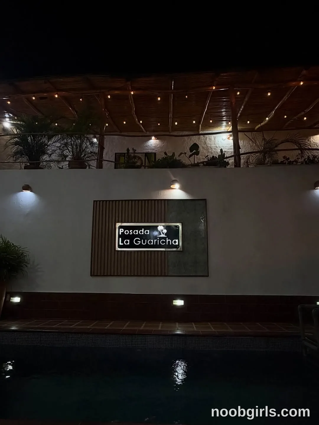 Ale nobody is visible in the frame in swimming pool patio area outside an inn or lodging in La Guaira