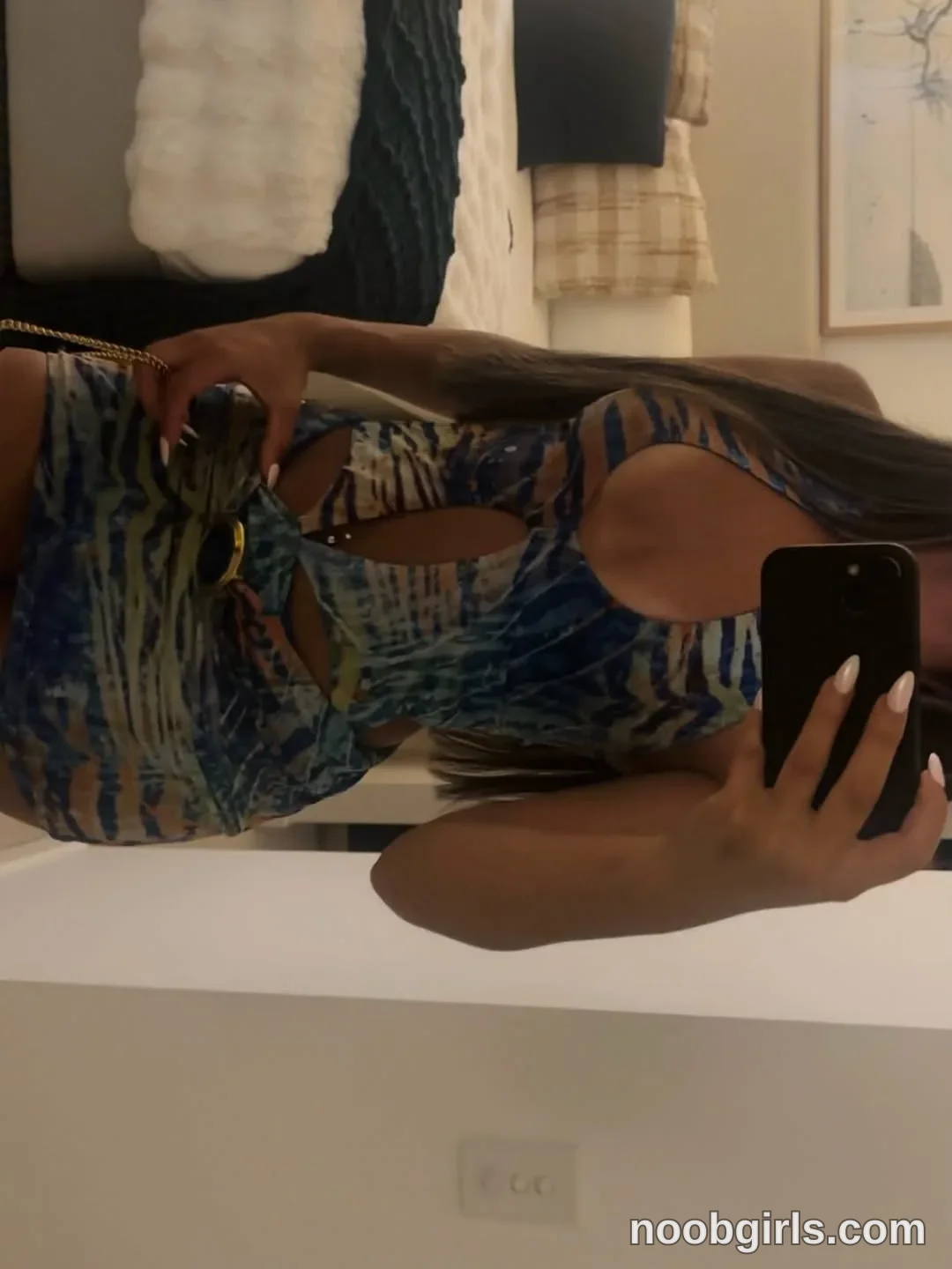 Ava Holding a smartphone toward a mirror for a selfie