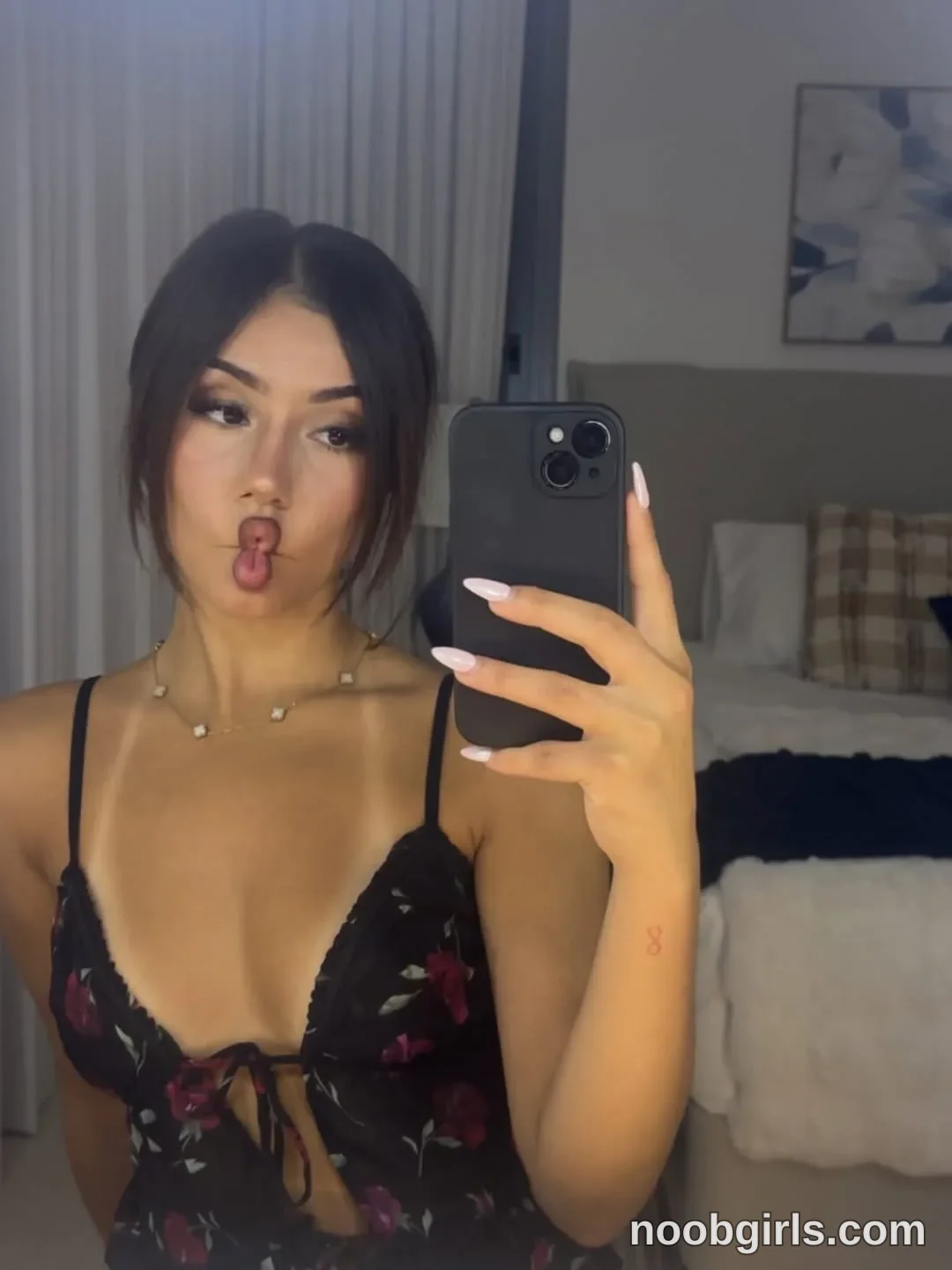 Ava Holding a smartphone in one raised hand for a mirror selfie