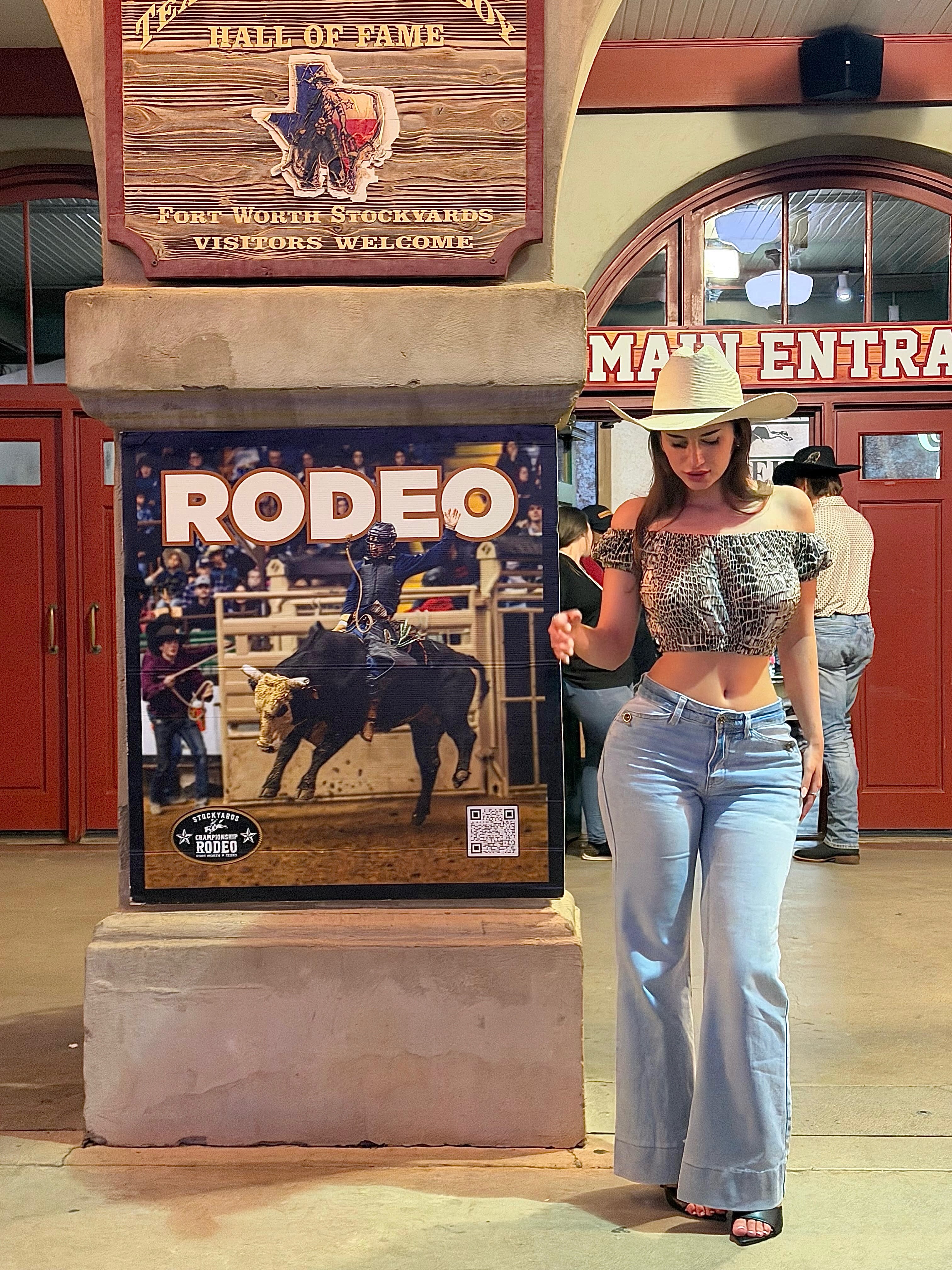 aviebby walking wearing white cowboy hat in building entrance at Fort Worth Stockyards