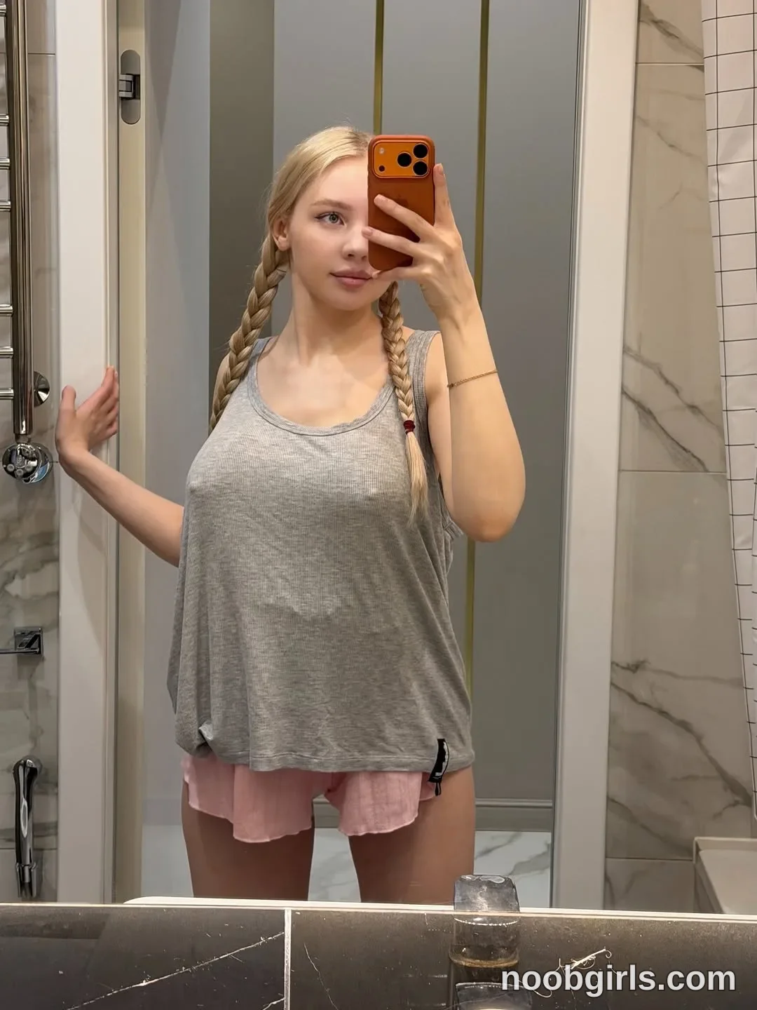 Avrora Standing in front of a mirror wearing Loose grey sleeveless tank top in bathroom