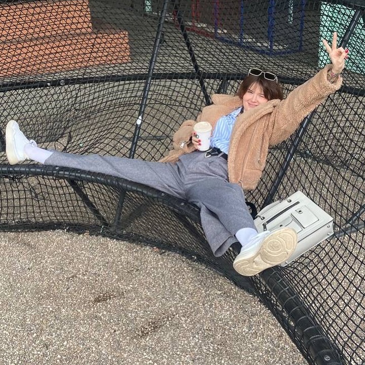 awondrr lounging wearing brown fleece jacket in rope structure