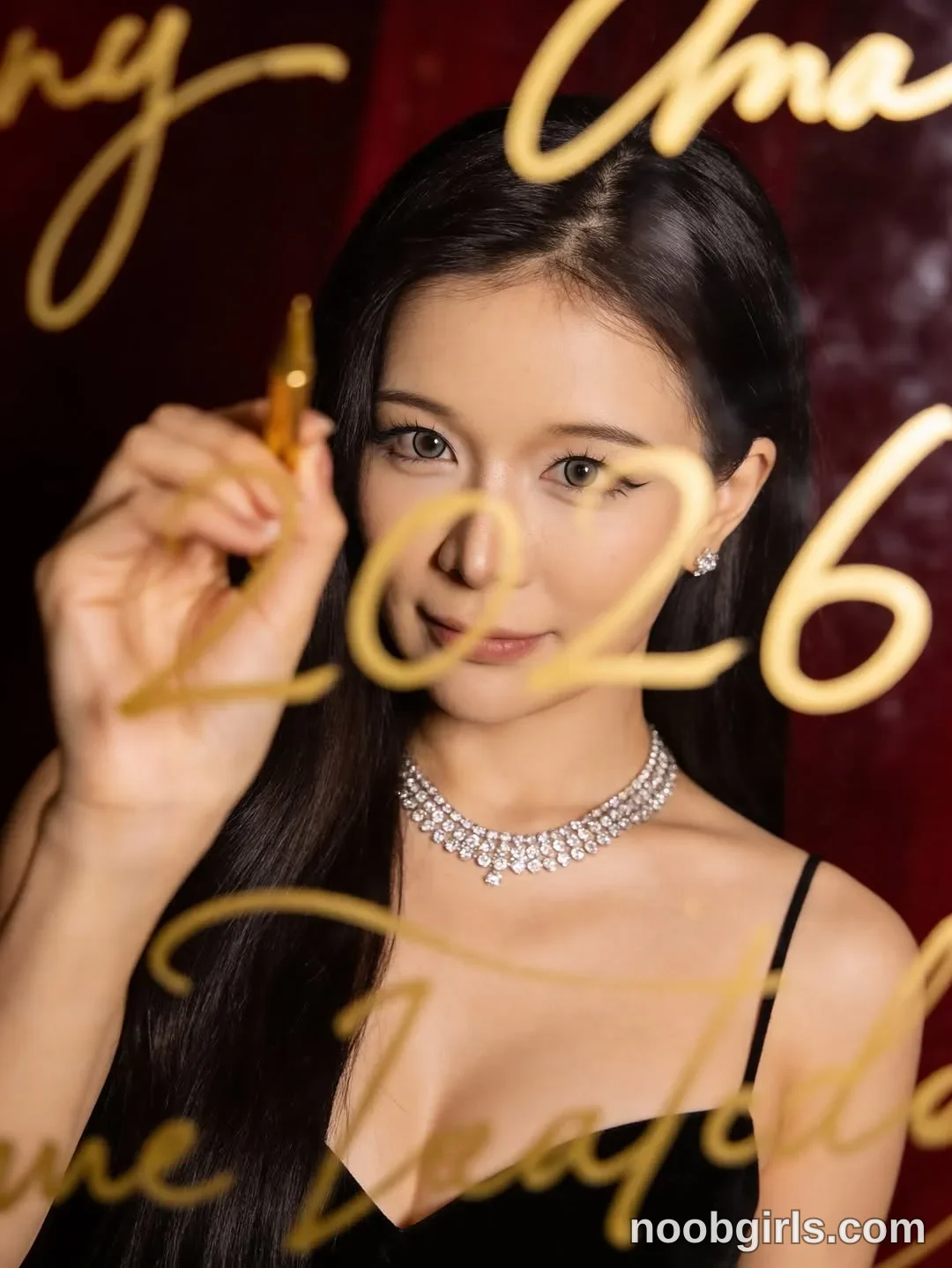 Bae Bae Holding a marker up to the transparent pane with one hand