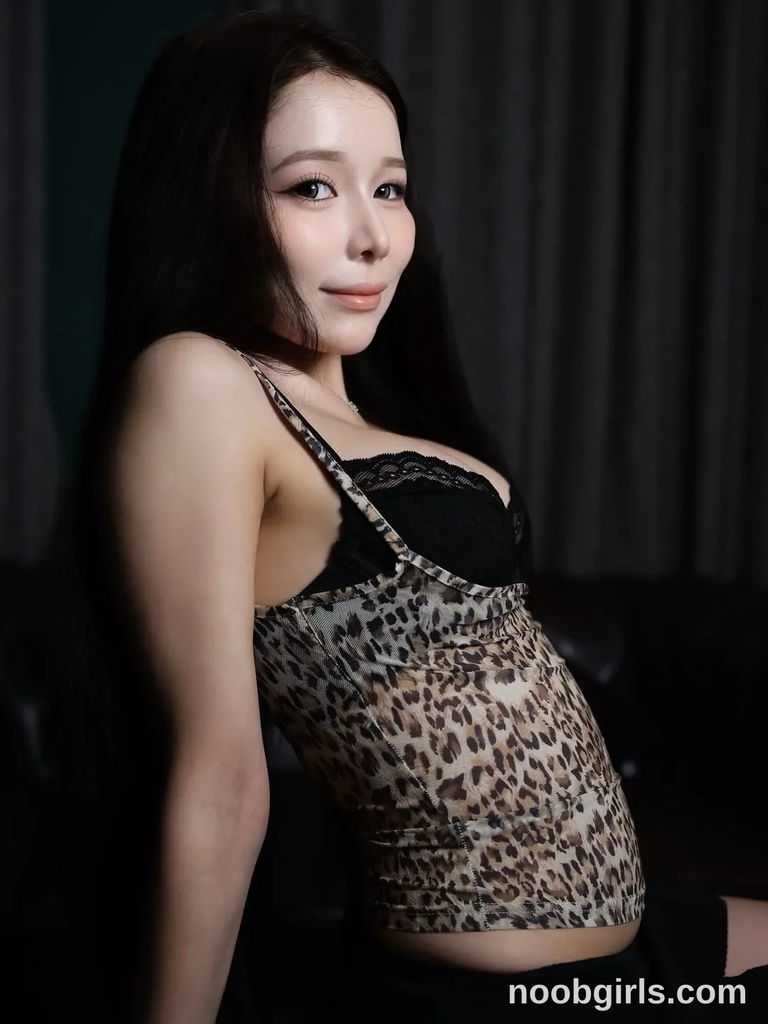 Bae Bae Leaning back with one arm extending downward wearing Leopard-print spaghetti-strap top in beige, brown and black