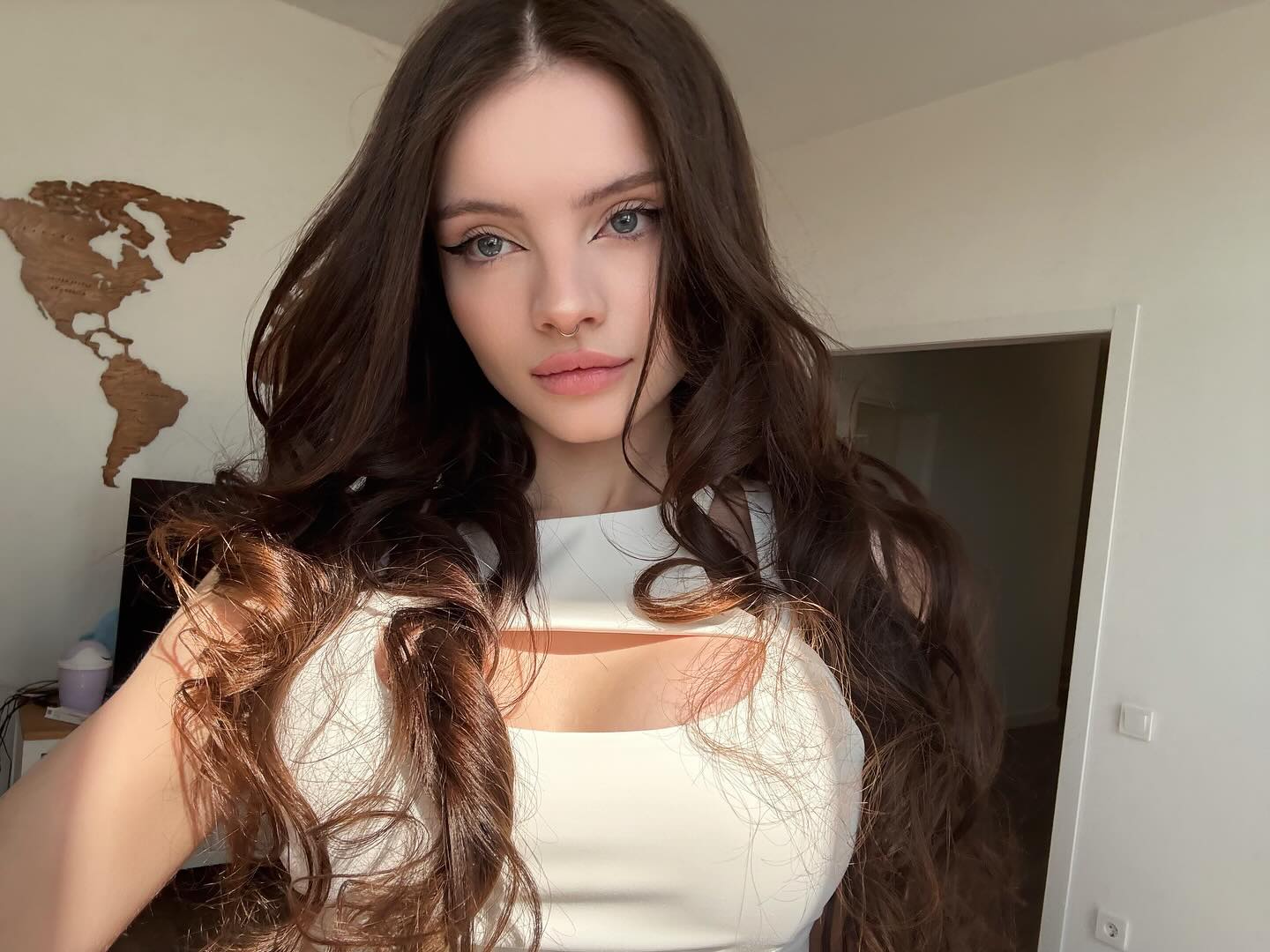 bellacle wearing white top in room