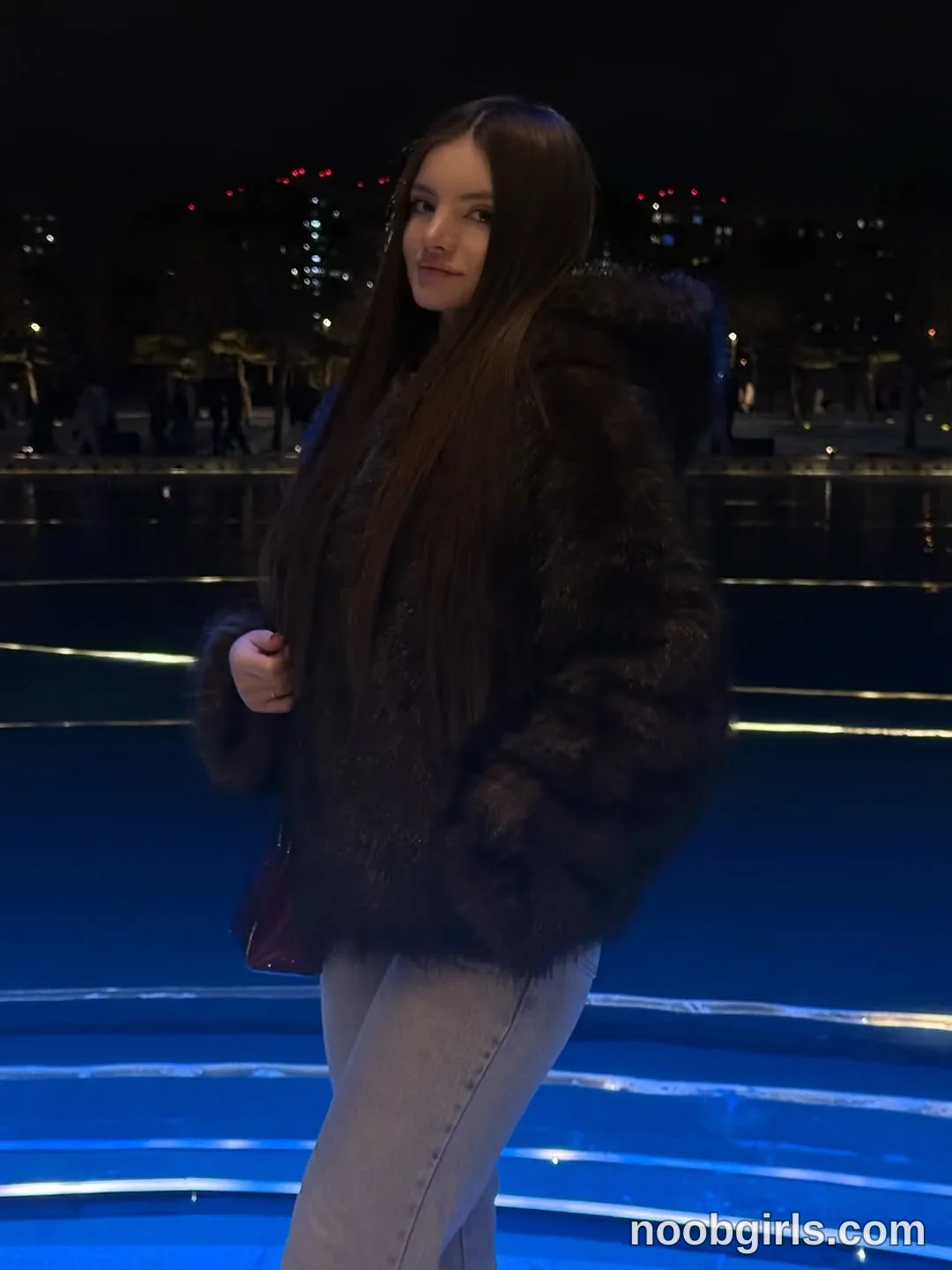 bellacle wearing dark brown or black faux fur or fur hooded jacket