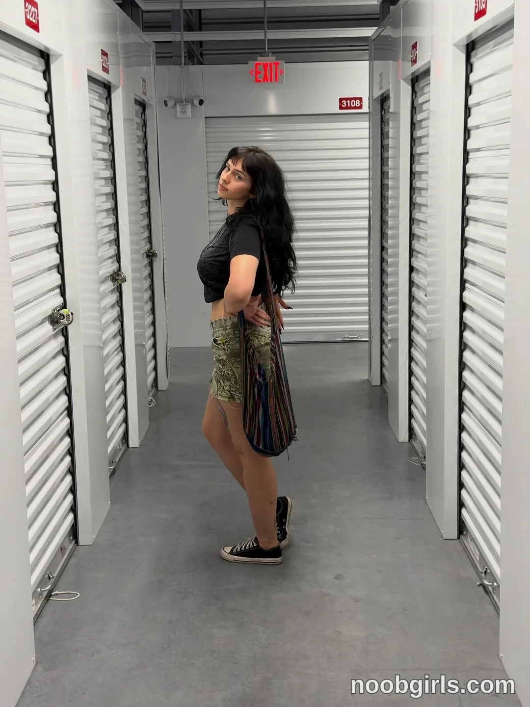 bexbex945874 wearing black cropped t-shirt in storage facility hallway