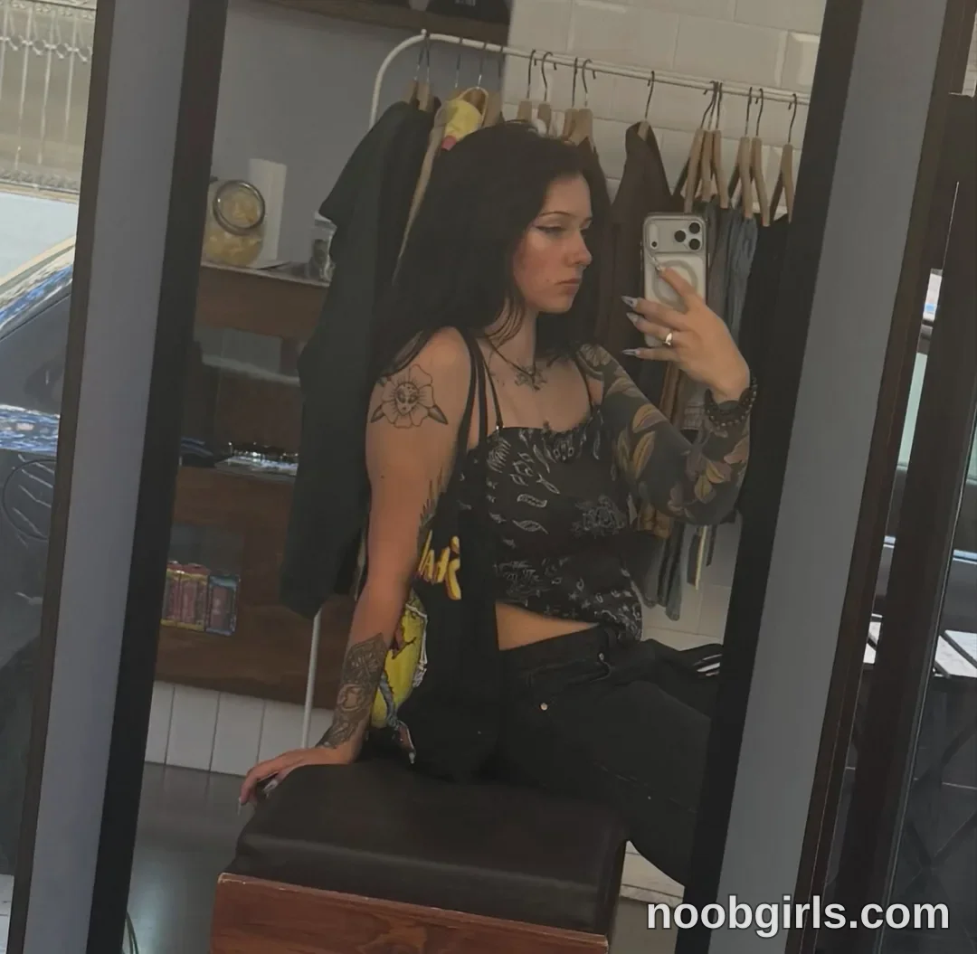 bexbex945874 taking mirror selfie wearing black patterned camisole in clothing store