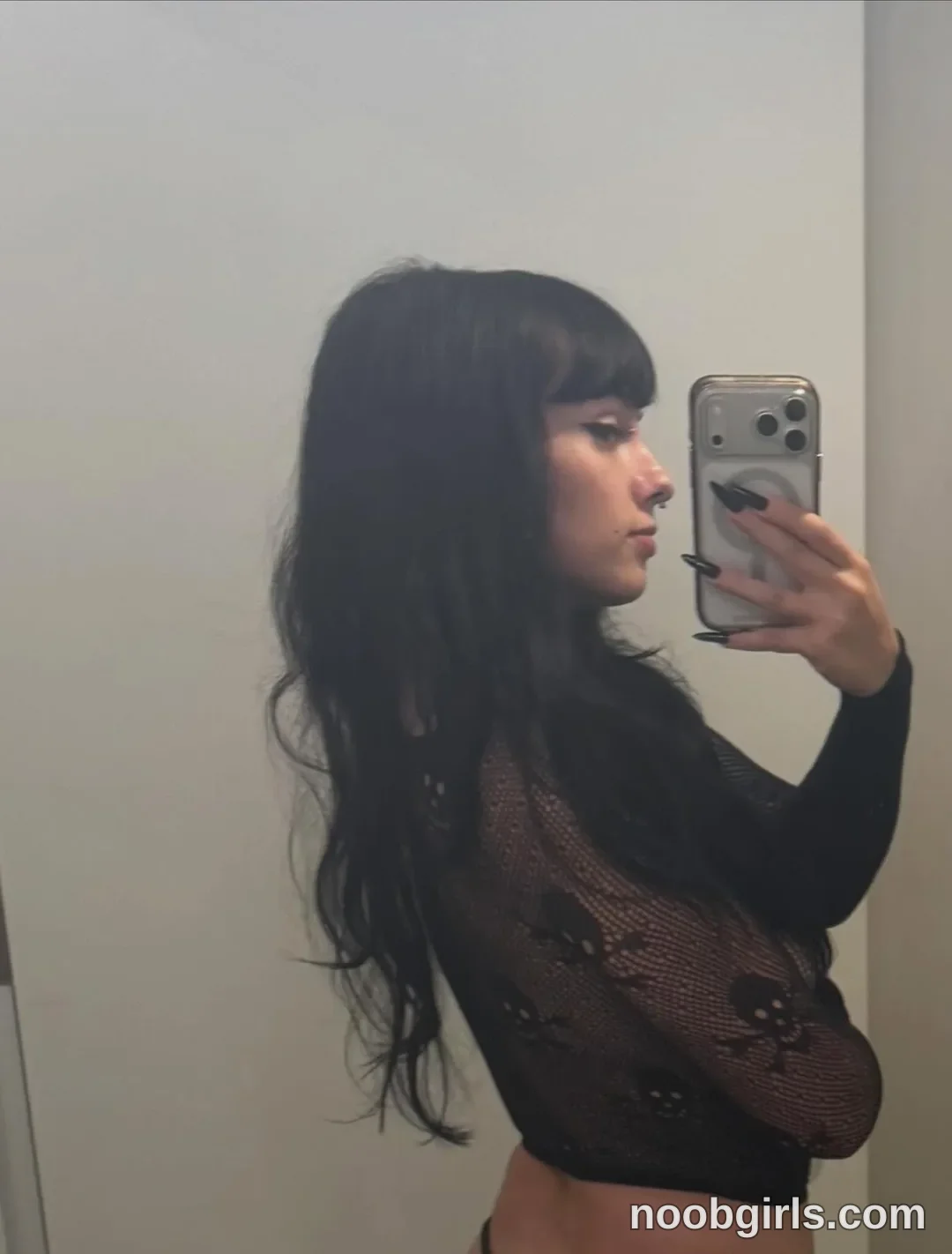 bexbex945874 taking a mirror selfie wearing black mesh top with skull pattern