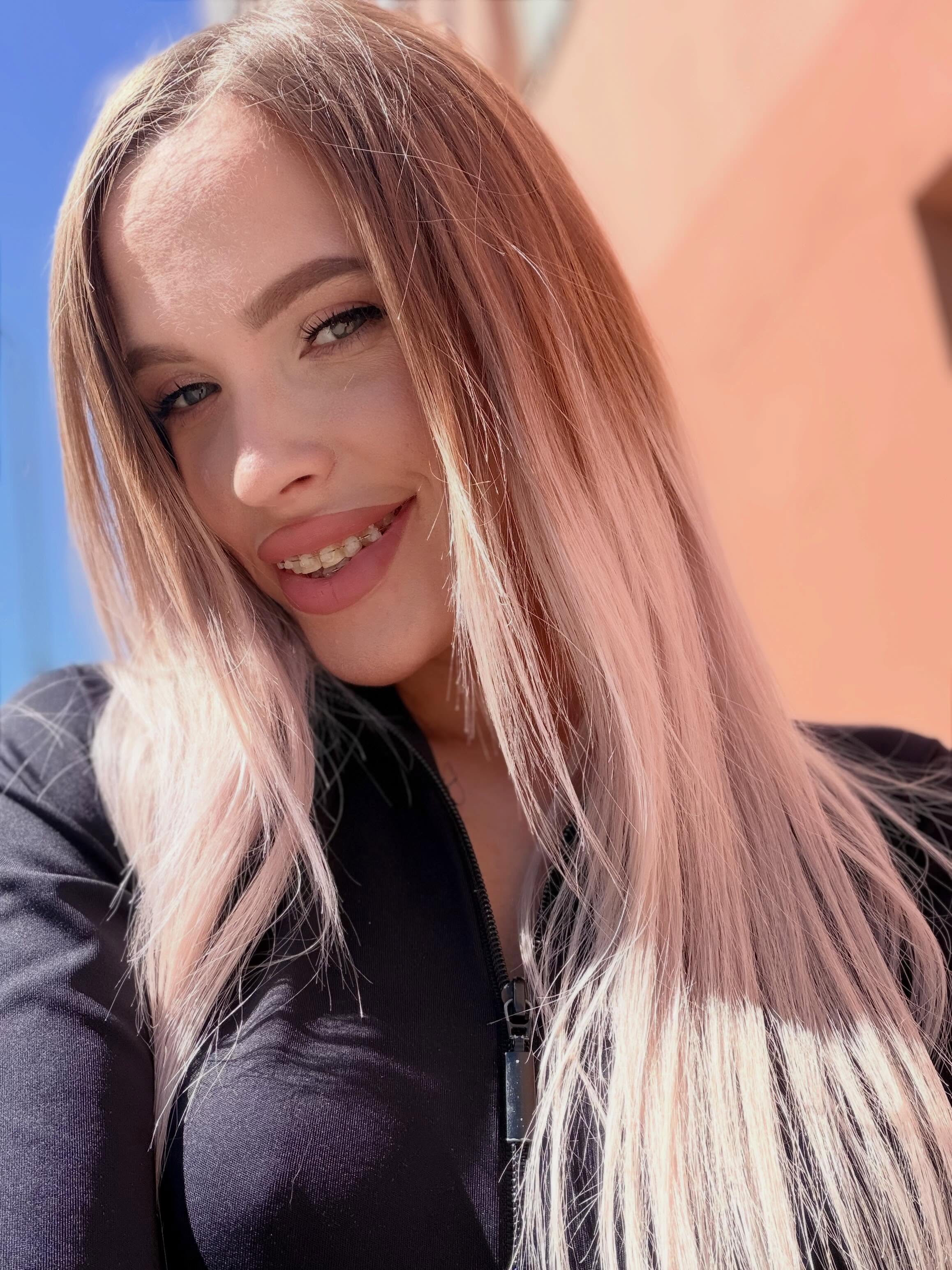 blush_mikki smiling at camera wearing black zipped top