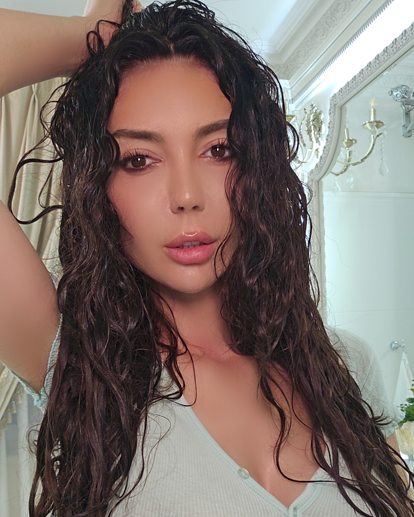 caylin taking a selfie wearing light green top in room