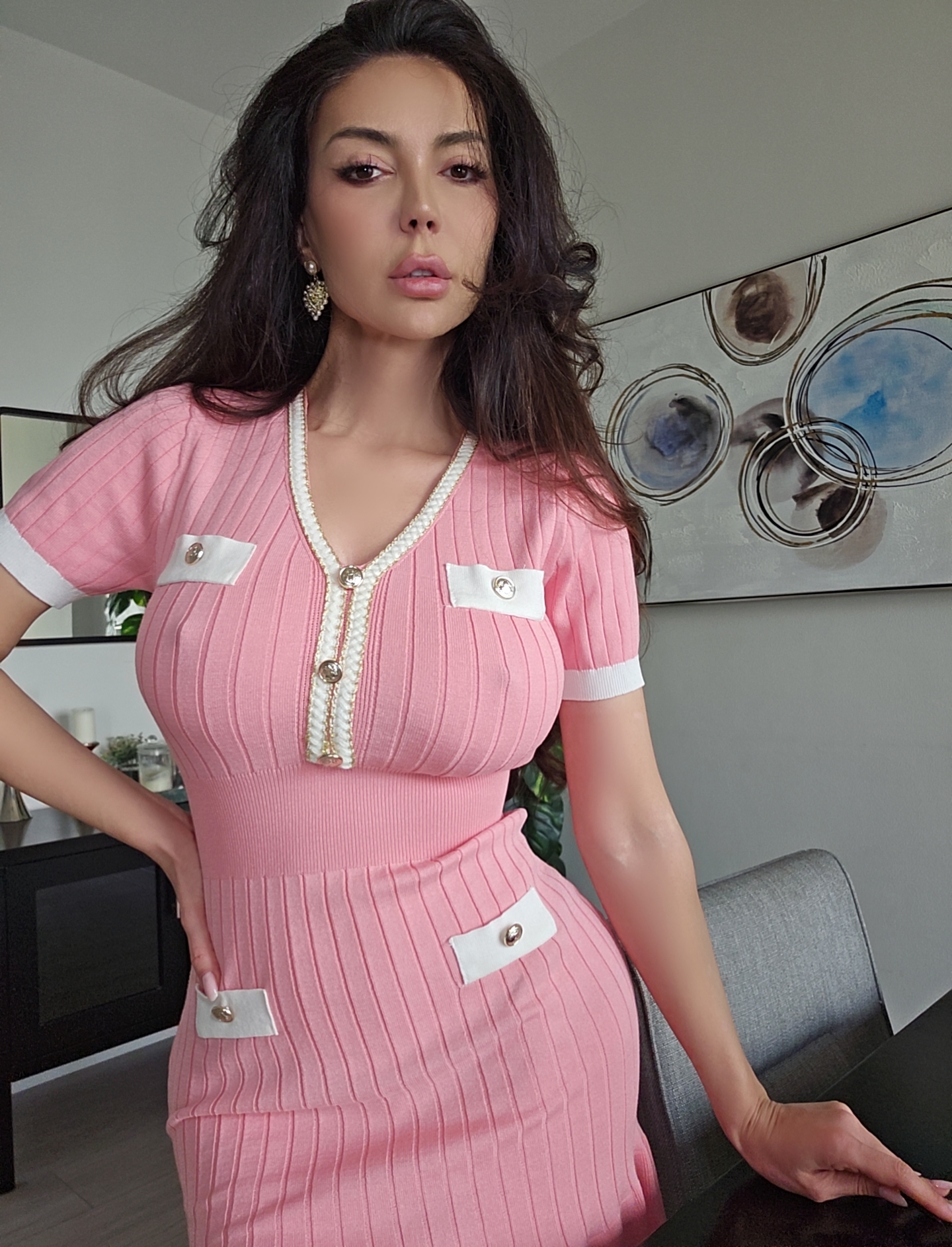 caylin wearing pink ribbed knit dress with white trim in dining room