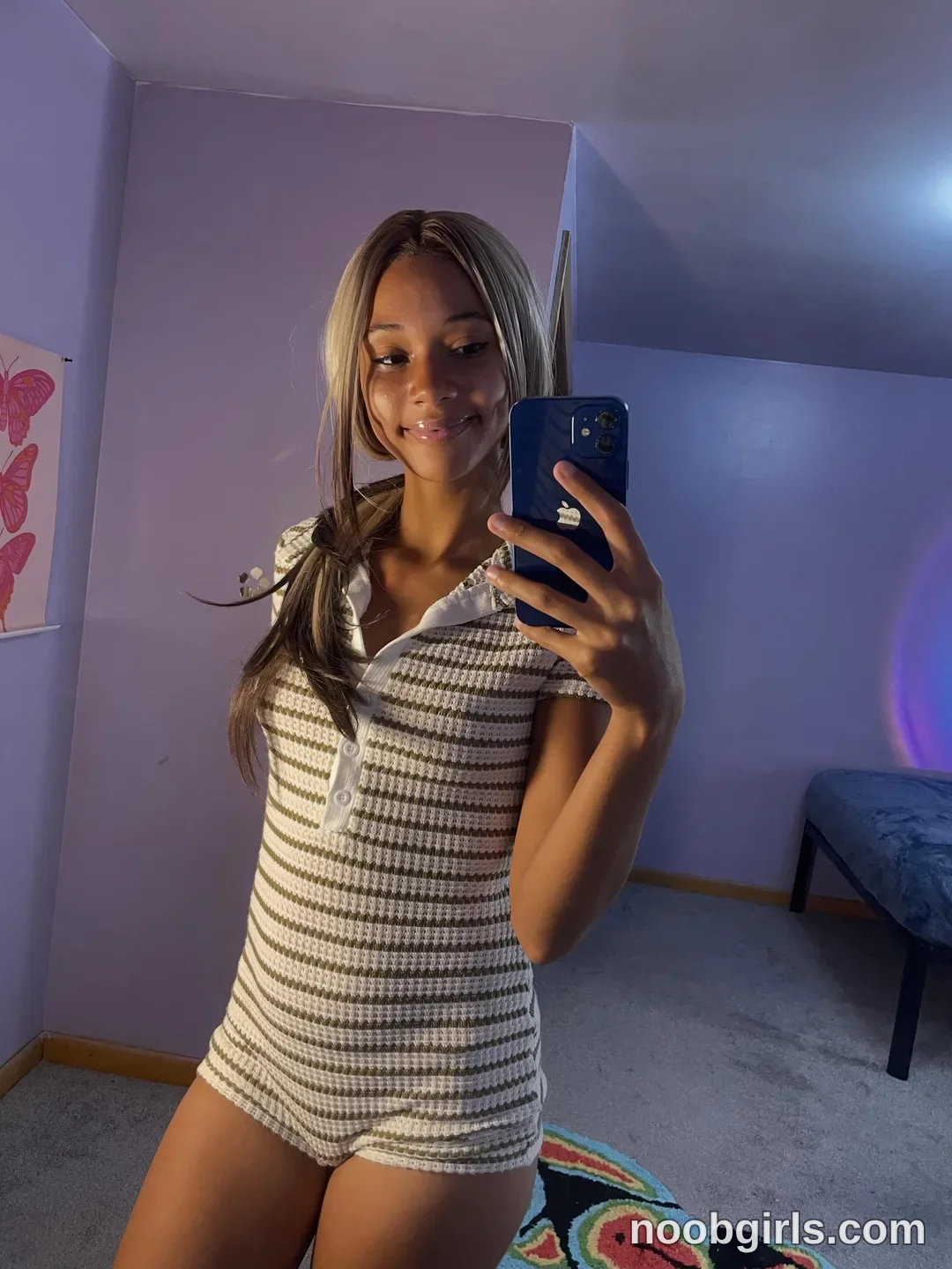 Cedaya taking a mirror selfie with a smartphone wearing white and olive green striped short-sleeved collared romper/playsuit