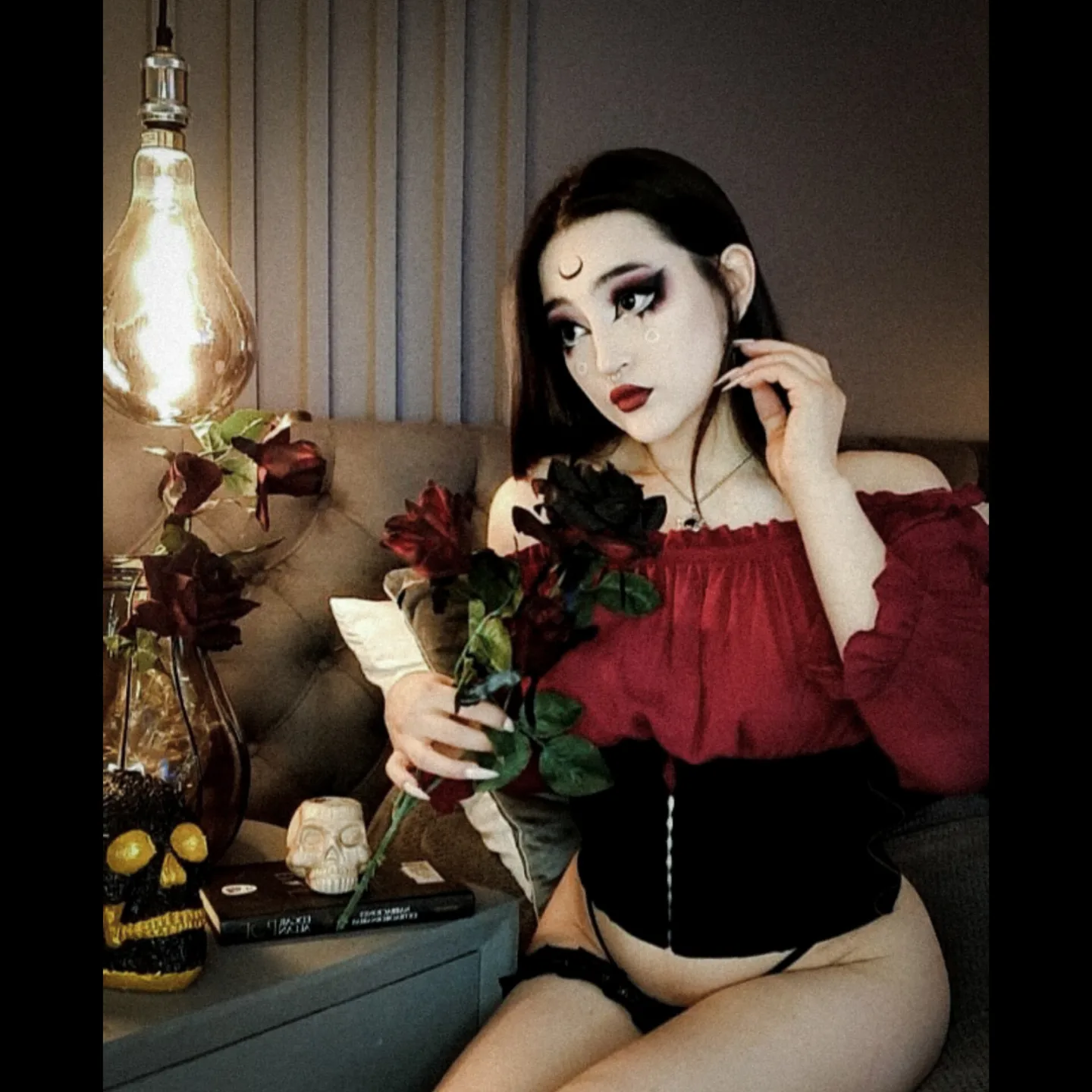 charlotte_germanotta_ holding roses wearing red off-shoulder top in room
