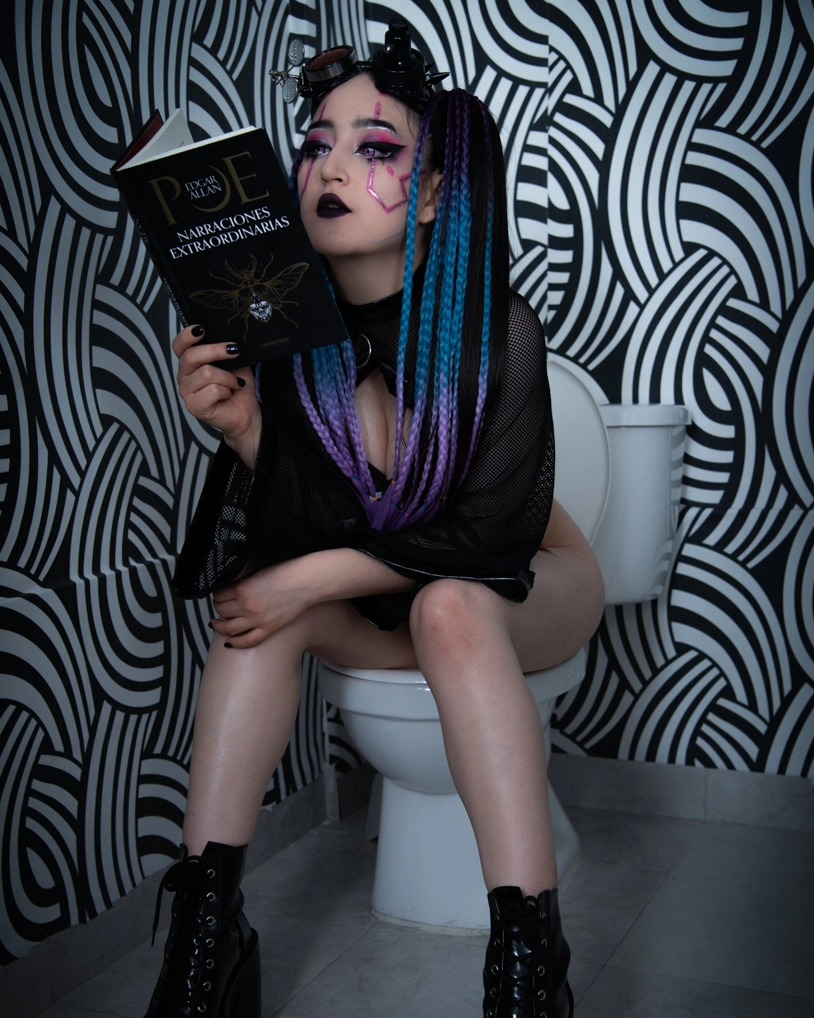 charlotte_germanotta_ sitting on a toilet reading a book wearing black mesh top in bathroom