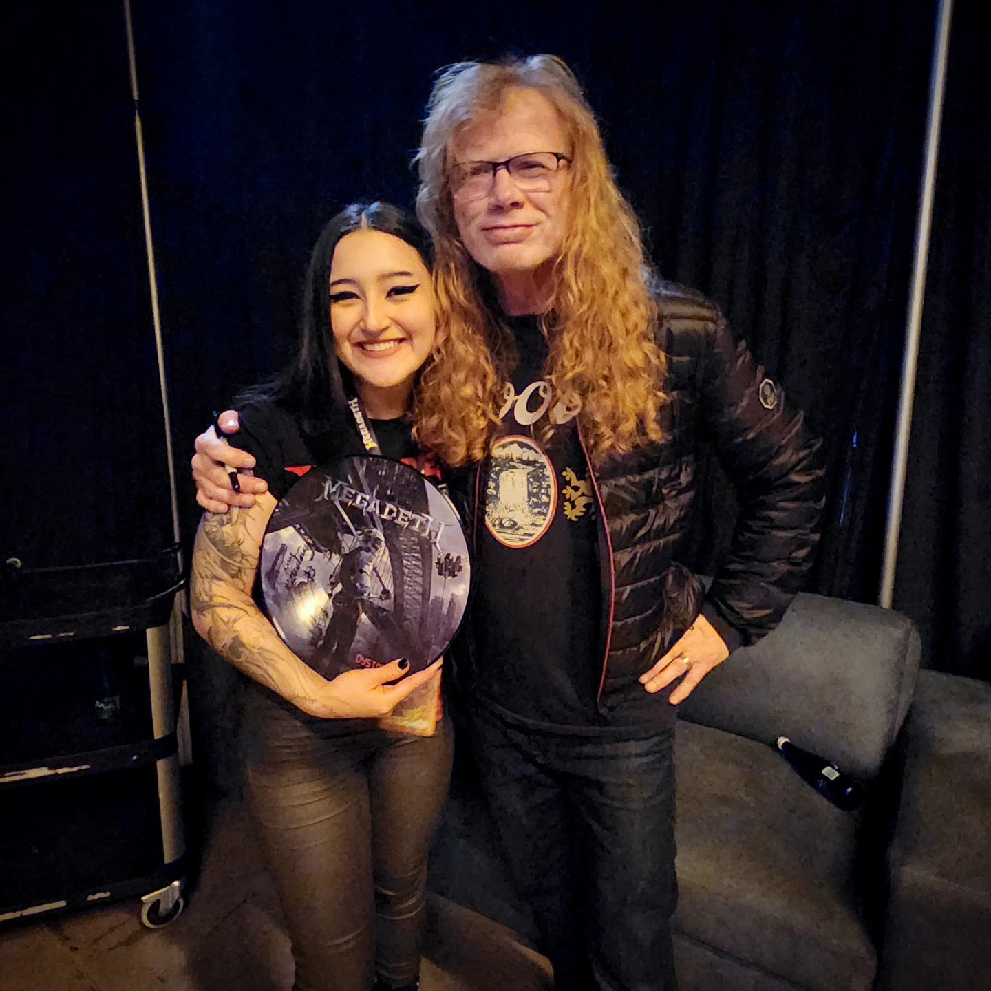 charlotte_germanotta_ posing together holding a record wearing black graphic t-shirt in room