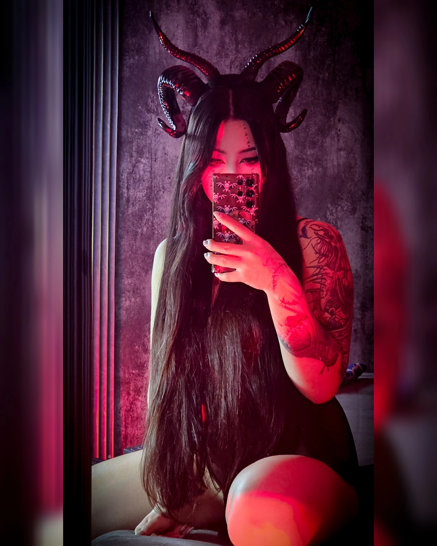 charlotte_germanotta_ taking a mirror selfie wearing black horn headpiece